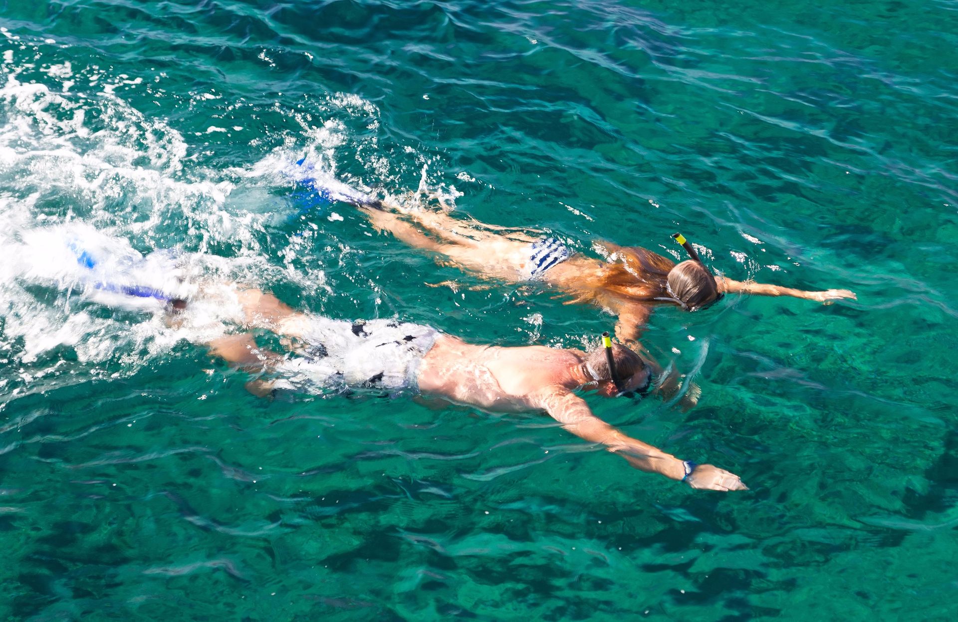 Snorkeling in crystal clear waters in Cova des Vell Mari, an arms length from Port de Sóller