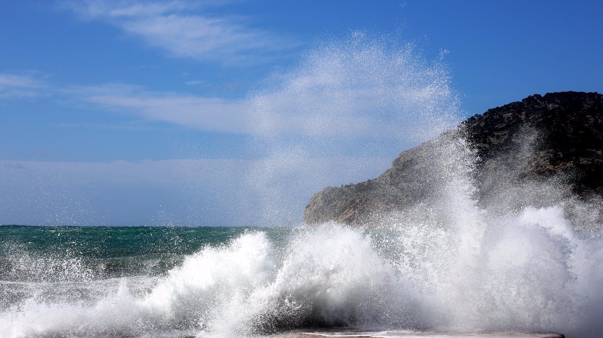 Wild waves crash against the beach in Port d'Andratx