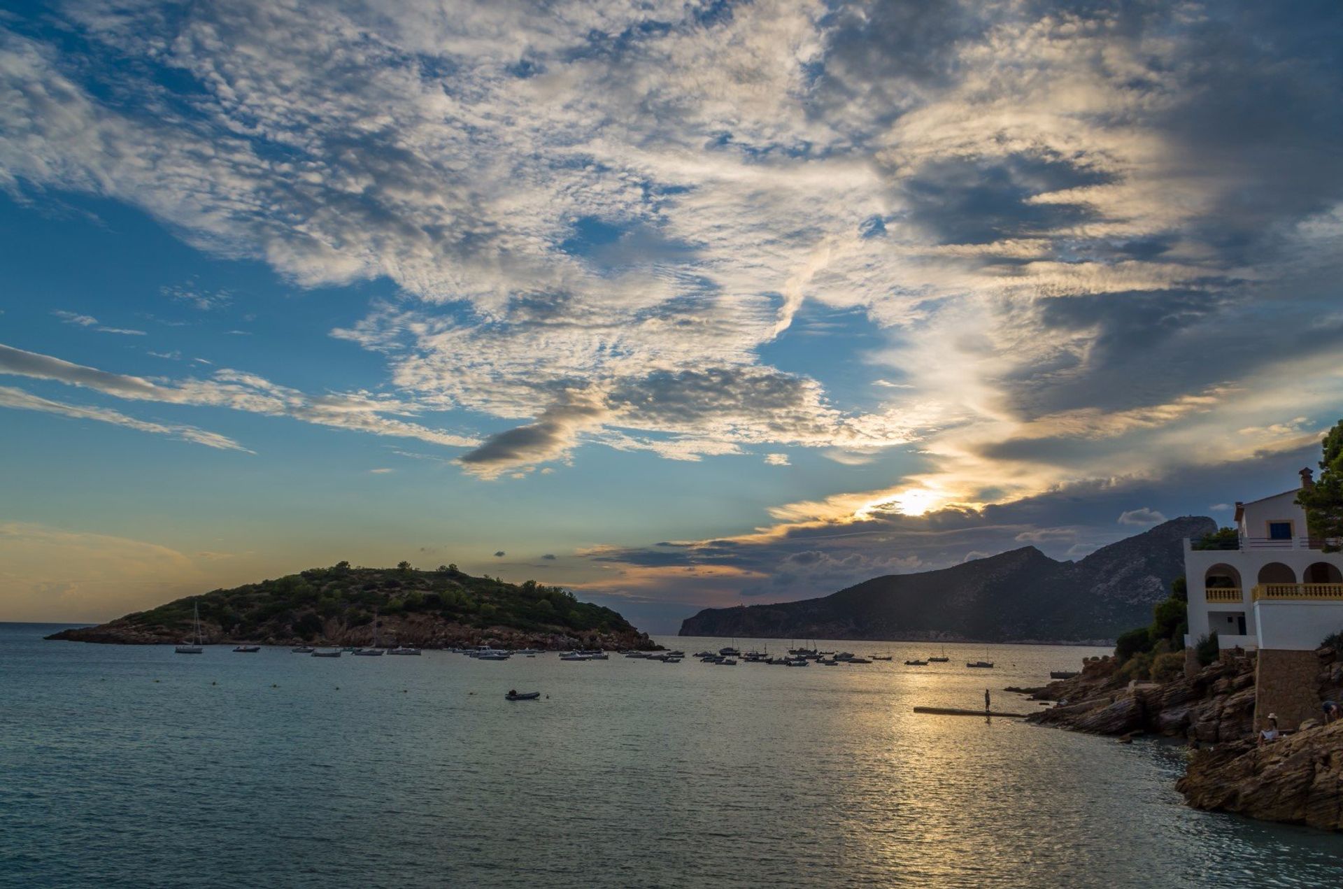 Glowing clouds behind the Serra de Tramuntana mountain range and Sa Dragonera island