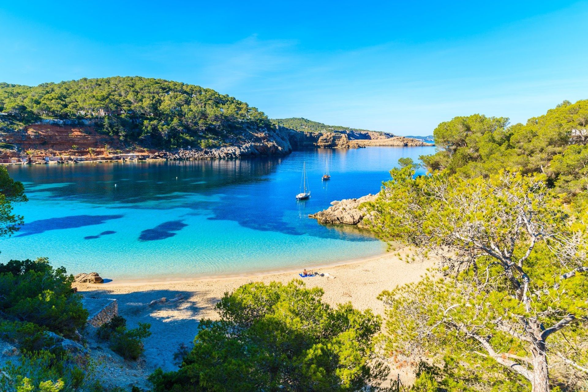 Azure blue sky and sea blending with Cala Salada beach