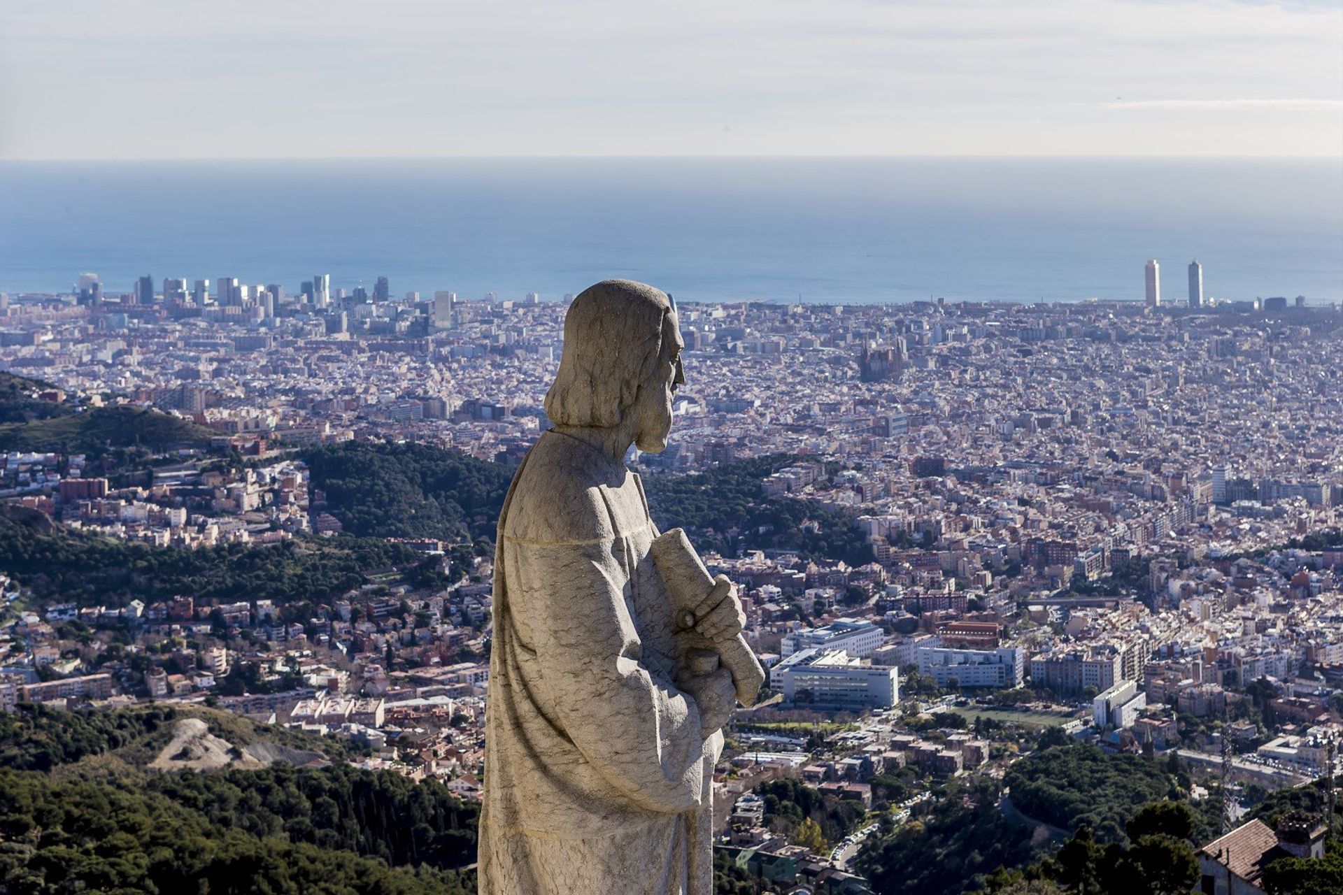 The statue of apostle and view of Barcelona from the top of Expiatory Church