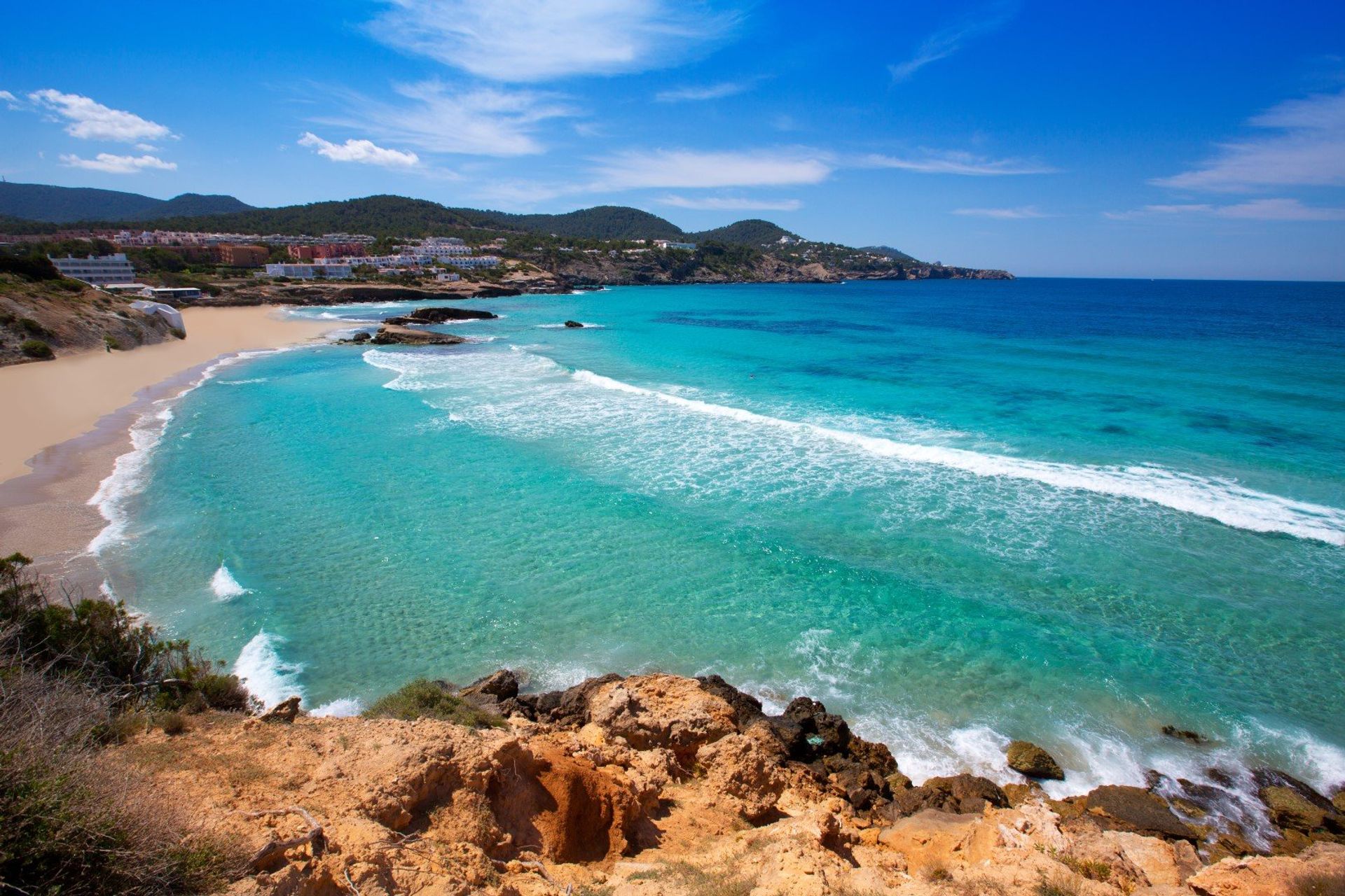 White sand Cala Tarida beach and its rocky coastline in San Jose, Ibiza
