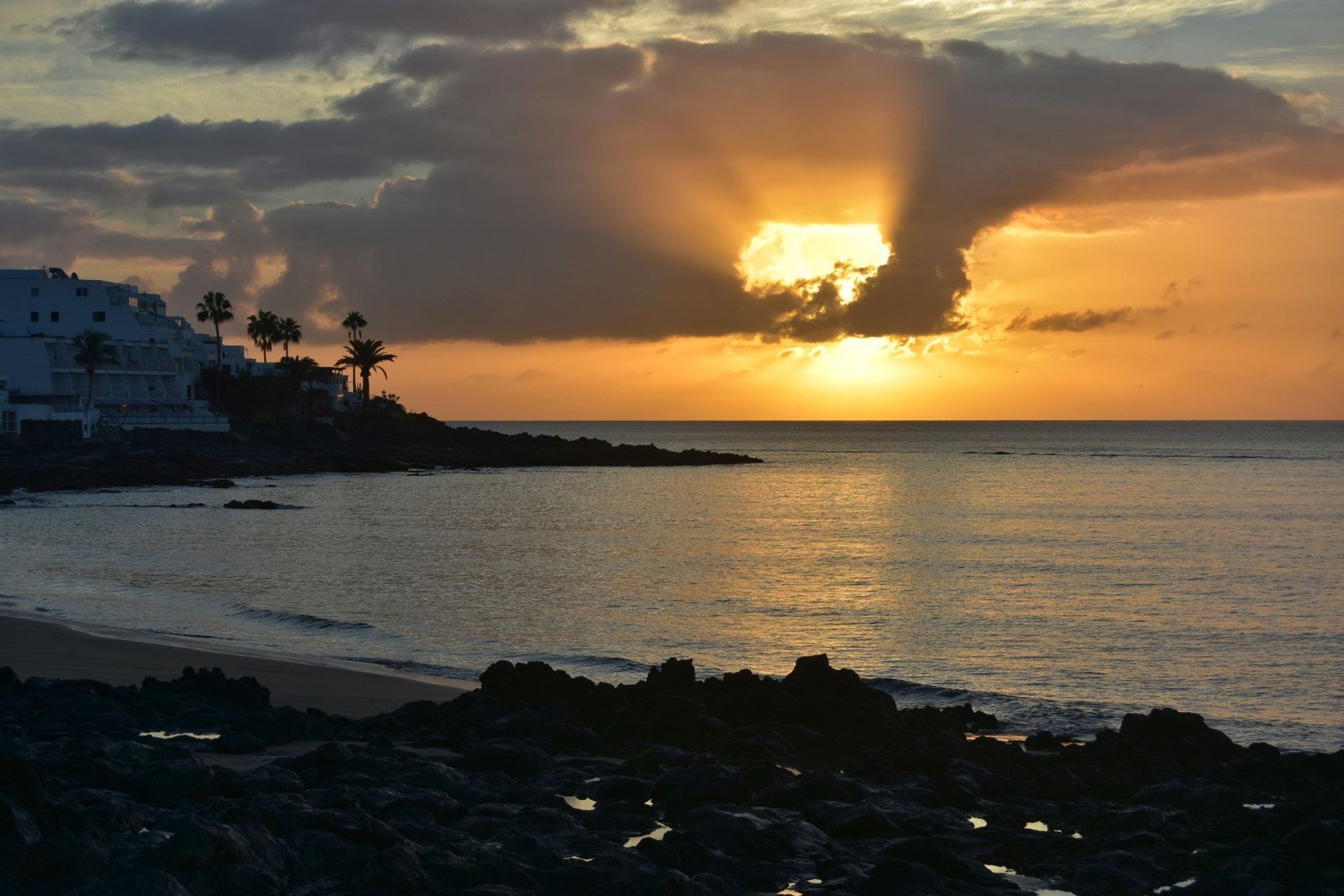 Gorgeous sunrise over the Atlantic Ocean kissing the sandy beach of Los Pocillos