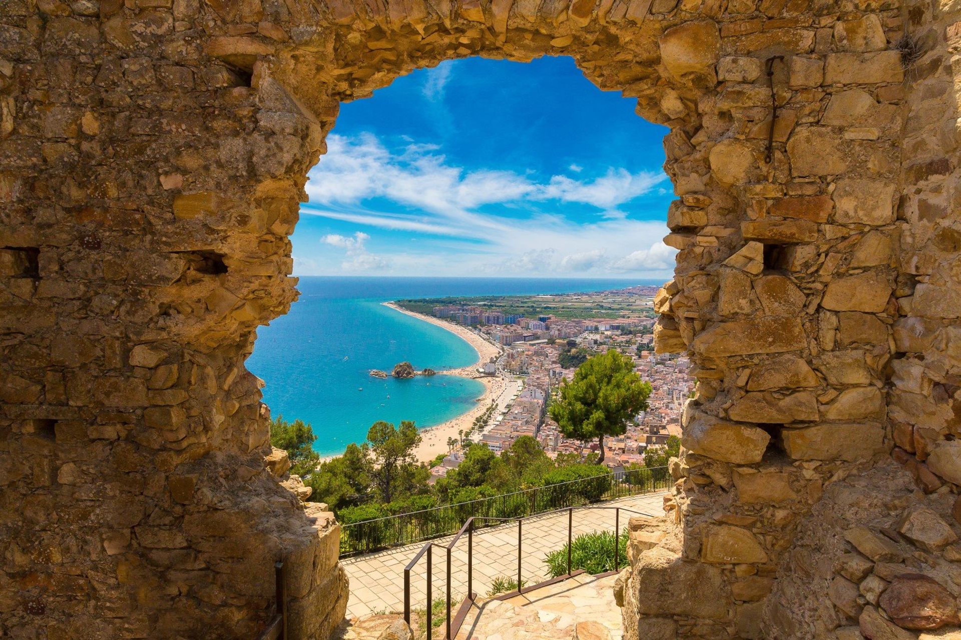 A window to paradise! Blanes beach seen through a hole in St. John Castle, in the region of Selva, Girona