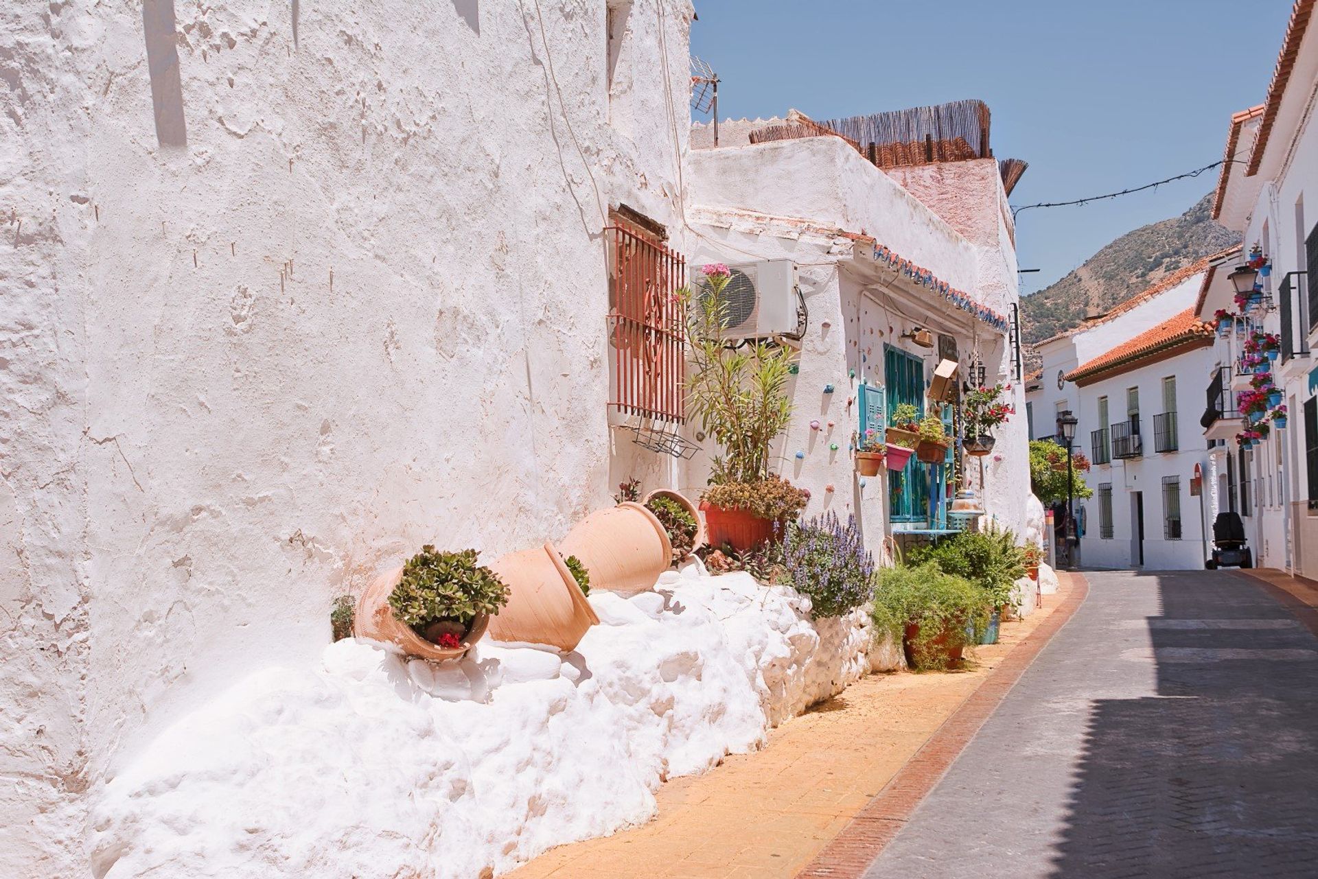 Colourful cobbled street in the old village of Benalmadena, decorated with flower pots