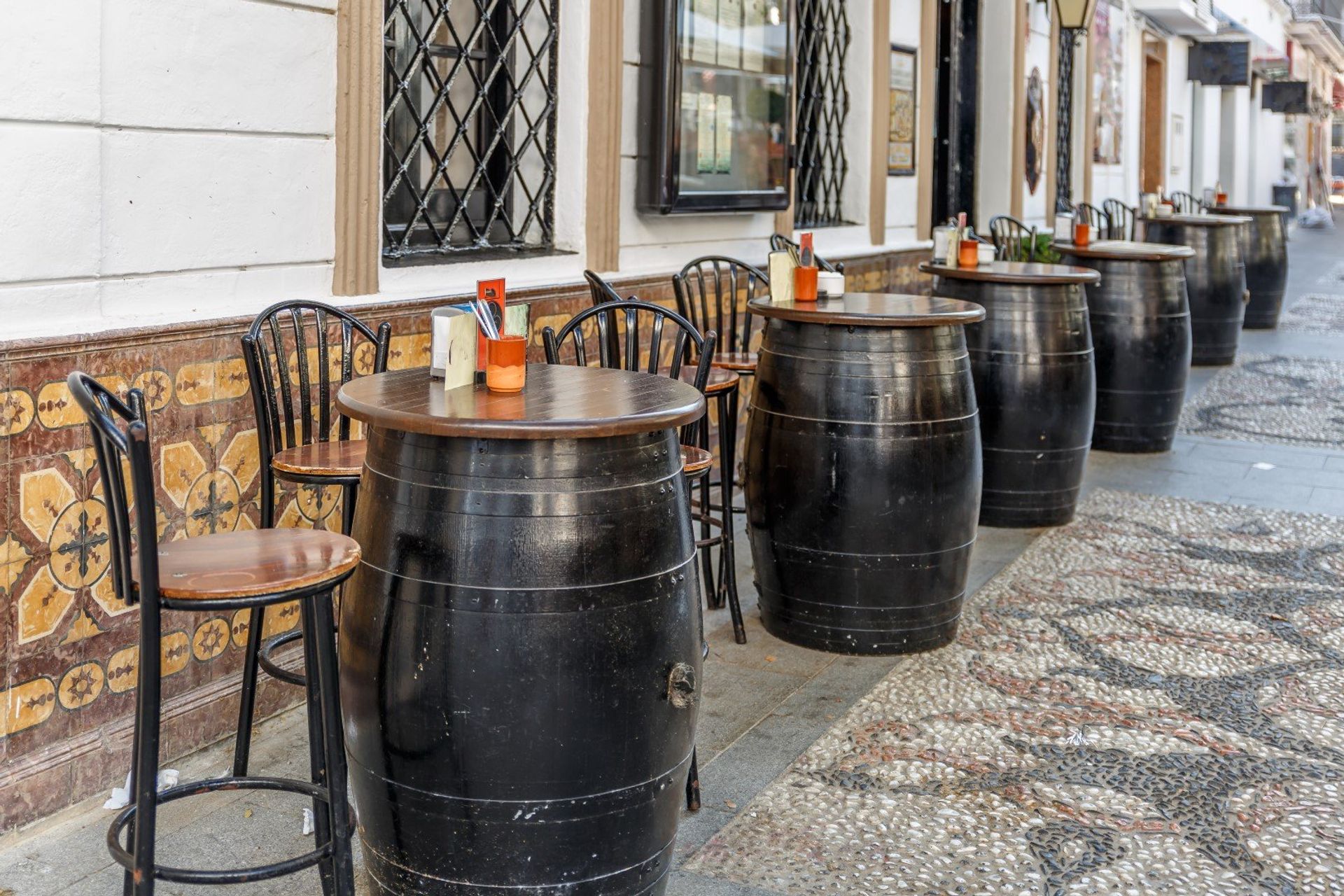 A typical Spanish bar serving traditonal tapas and beers, with oak barrel tables on the outside