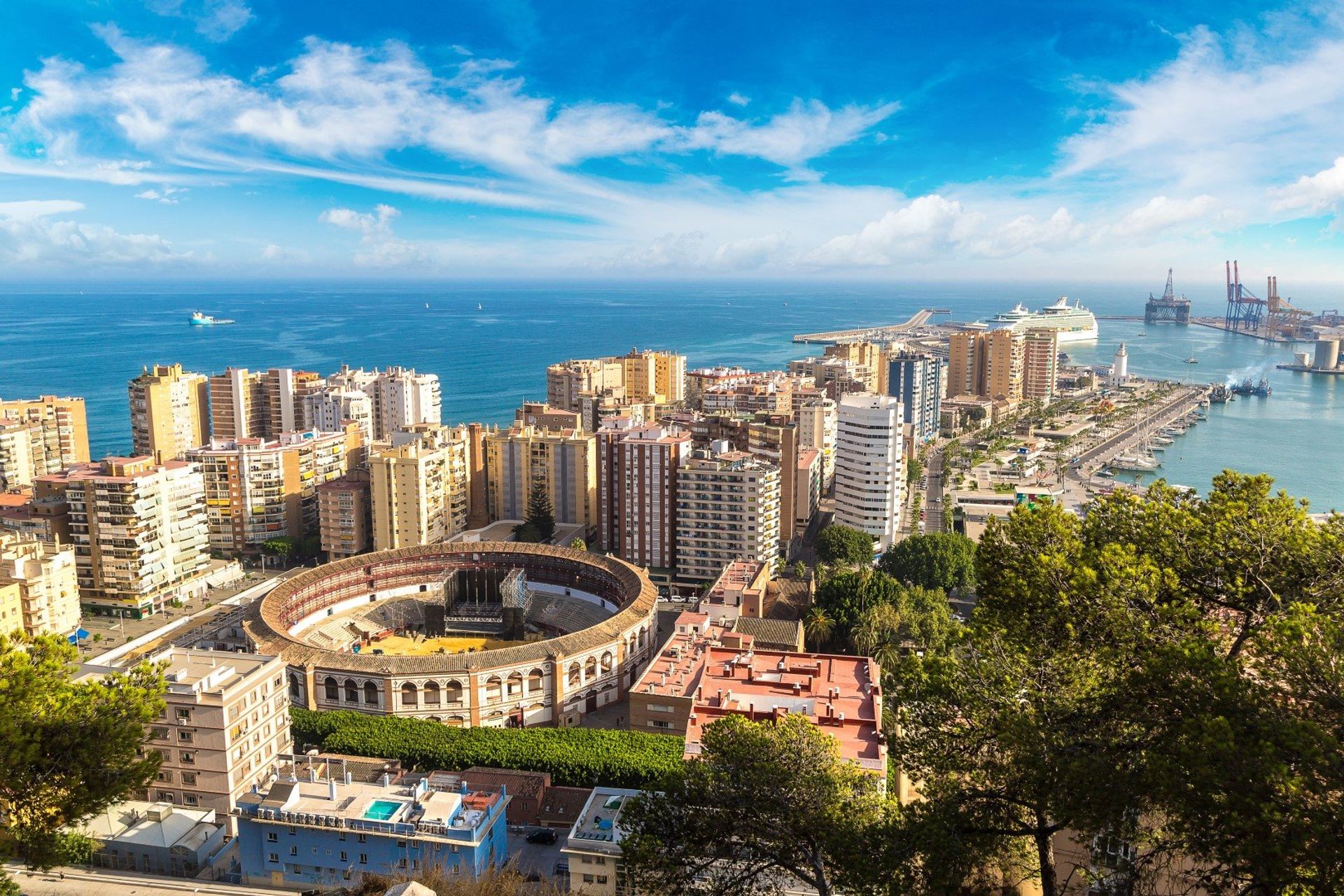 Cityscape of Málaga with the bullring in the centre and port in the background
