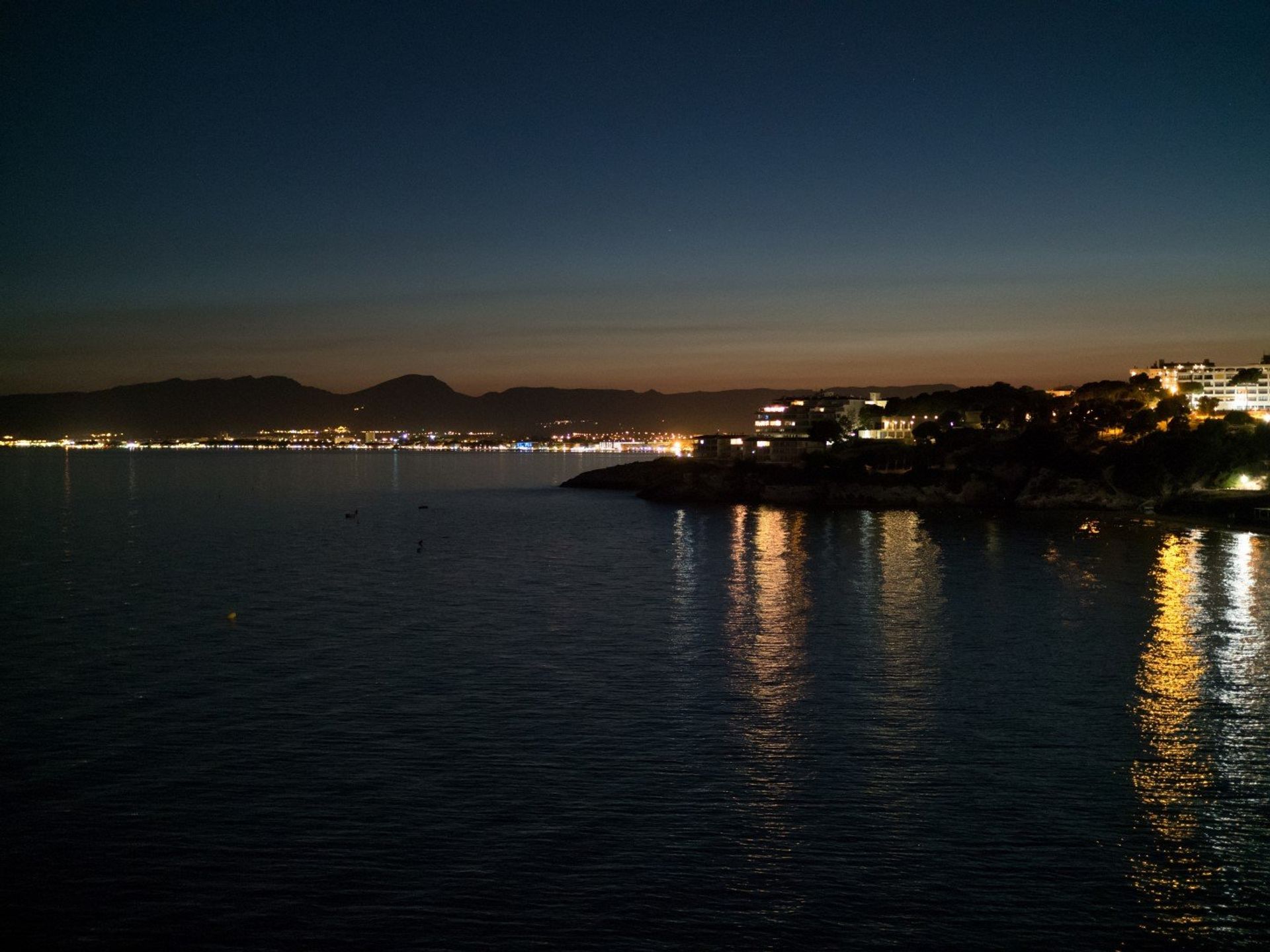 The bright lights of Salou town and Cap Salou at night
