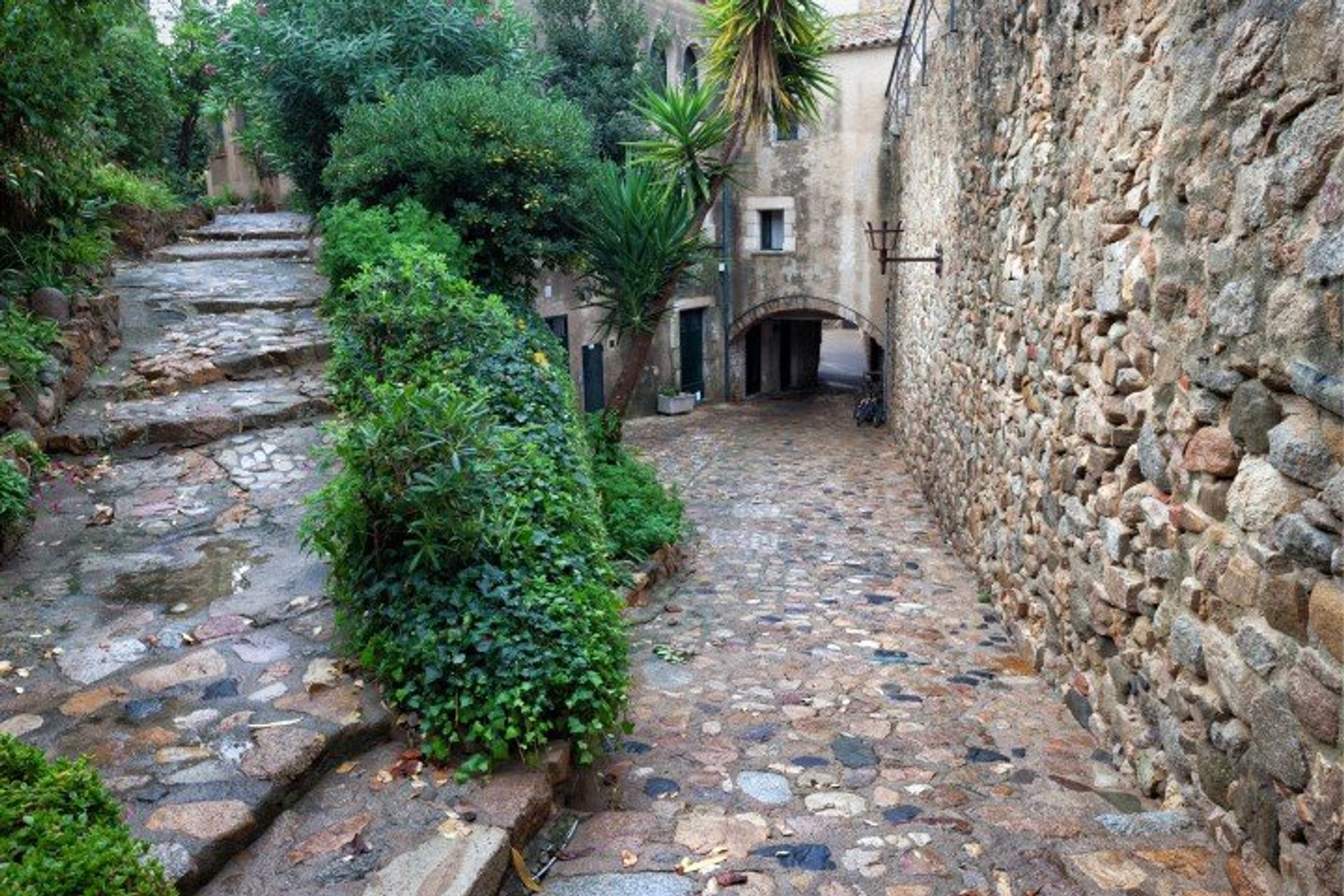 The cobbled streets and medieval walls of the old town Vila Vella