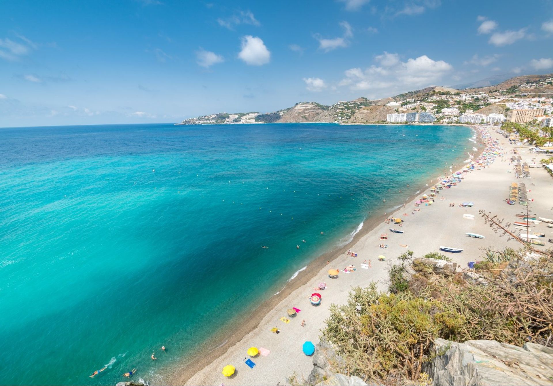 Dark sand San Cristobal beach has many chiringuitos and restaurants serving refreshments and delicacies like pescado frito