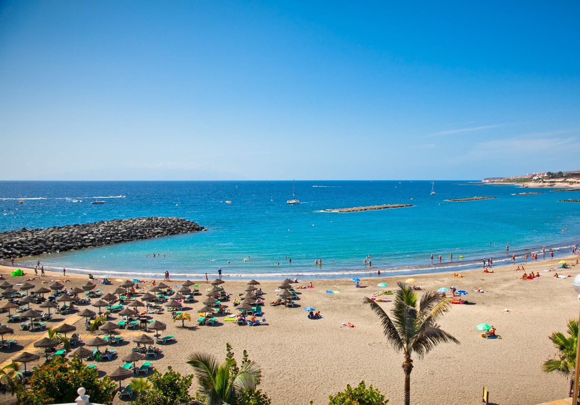 The blue waters, golden sands and lively atmosphere of Playa de las Americas, less than a 20 minute drive from Arona