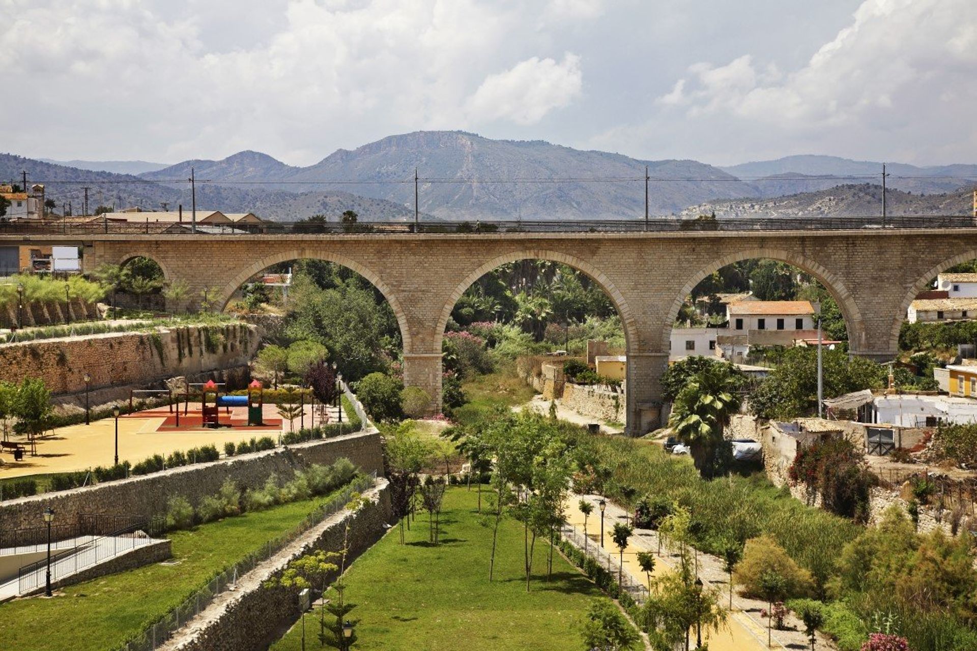 Discover a landscape of mountains and lush greenery, with brilliant views of the old town from Villajoyosa's bridge