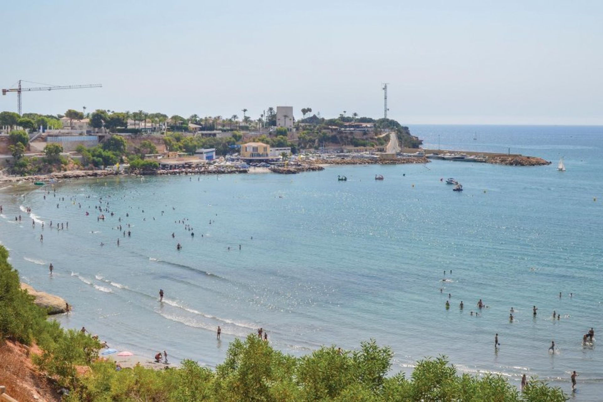 People watch, sunbathe or just sit and relax under the Mediterranean sun on the local Cala Cerrada beach