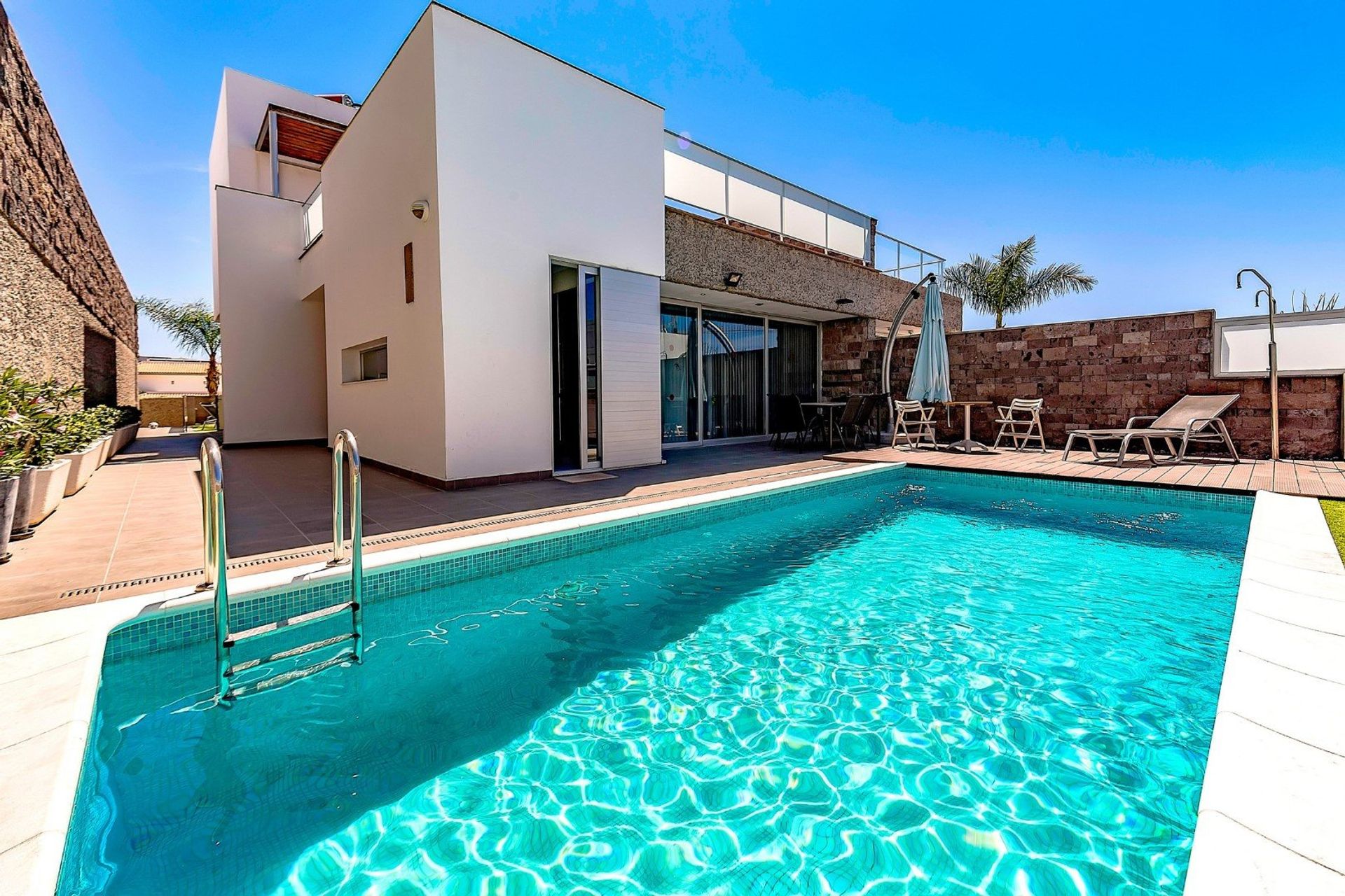 Fed up with the beach? Relax by the pool in this modern 6 bedroom villa near a beach and golf course