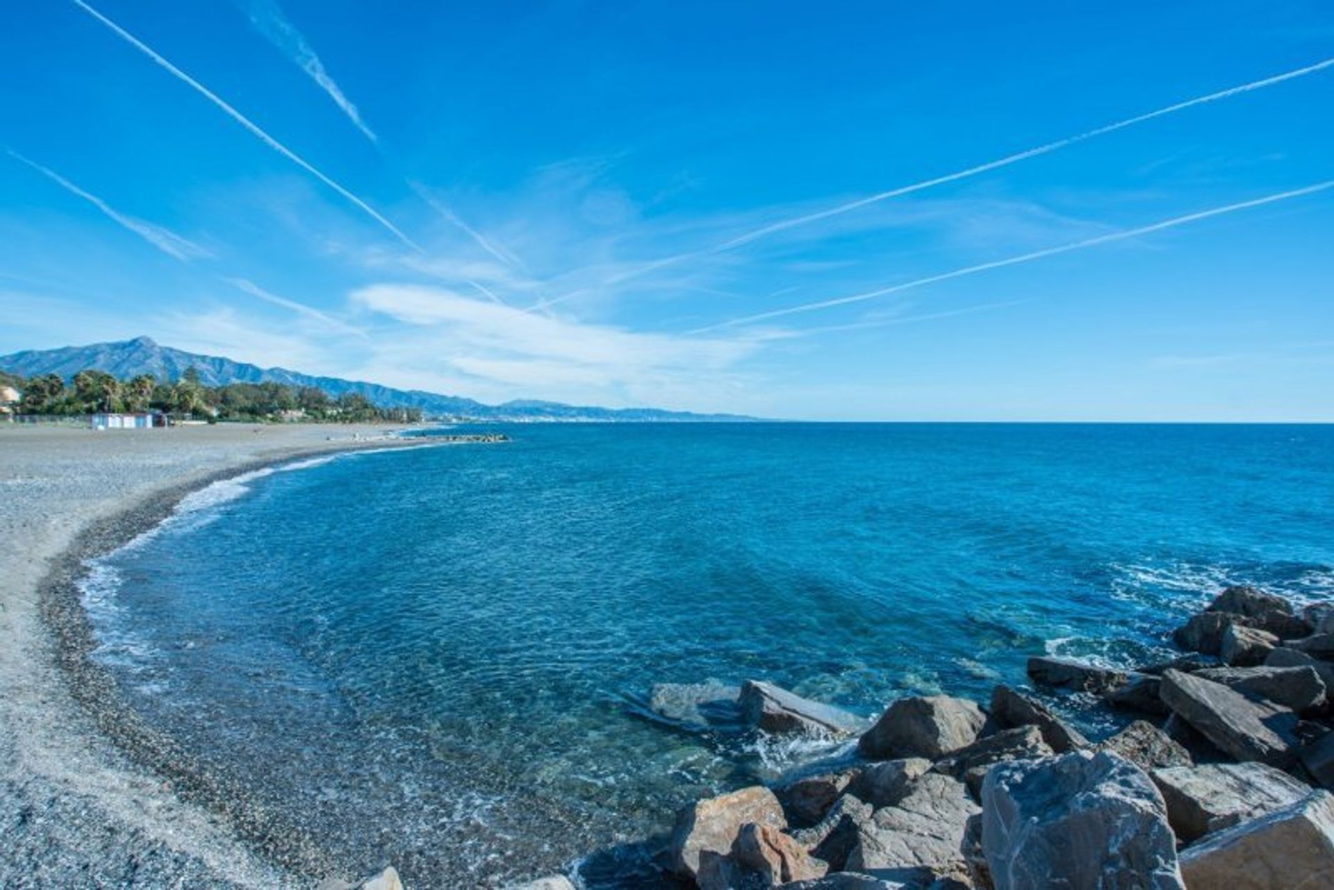 People watch, sunbathe and relax on Marbella's lively beaches, less than half an hour away