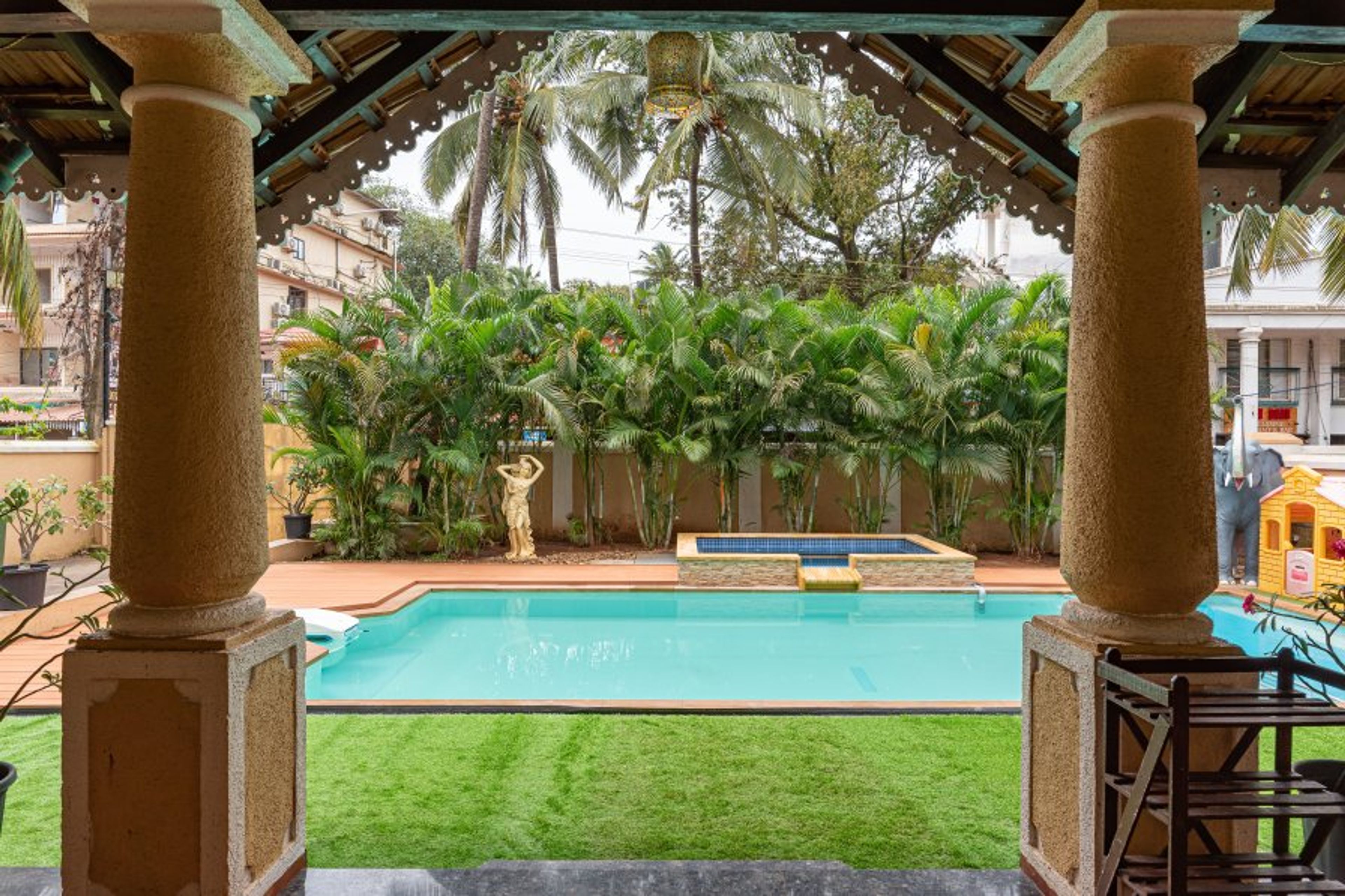 Enjoy a charming private sit out area with a vista of the pool