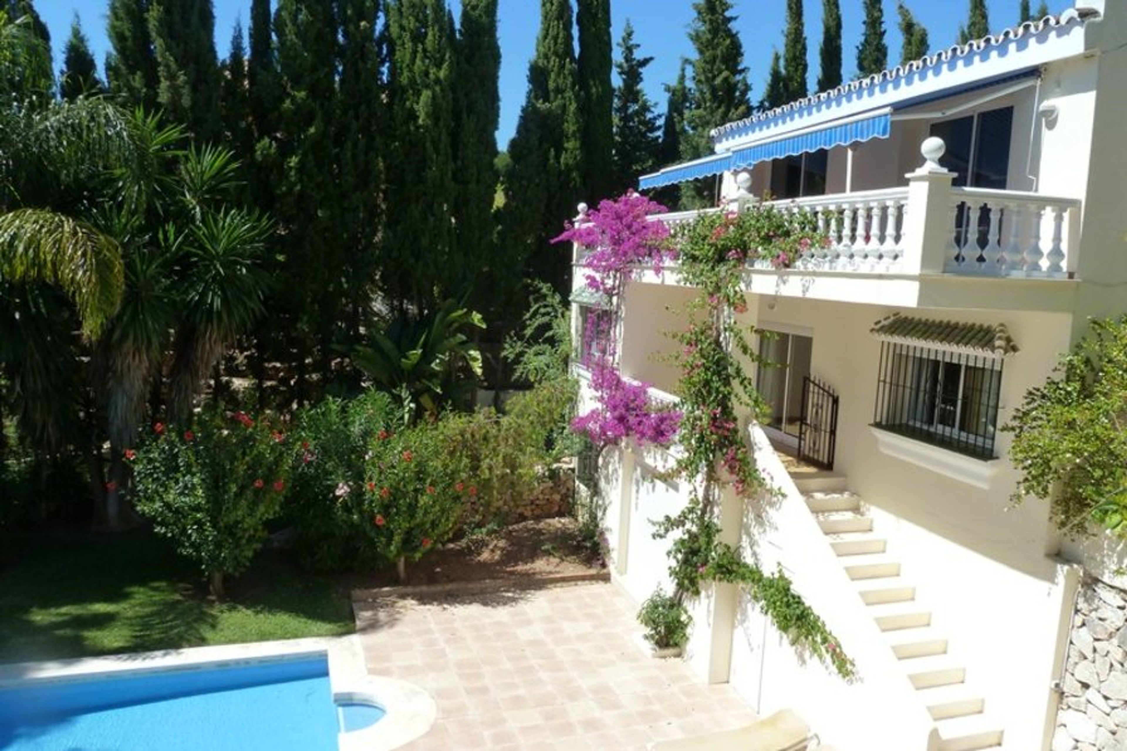 Side view of back of villa with terraces and patio area