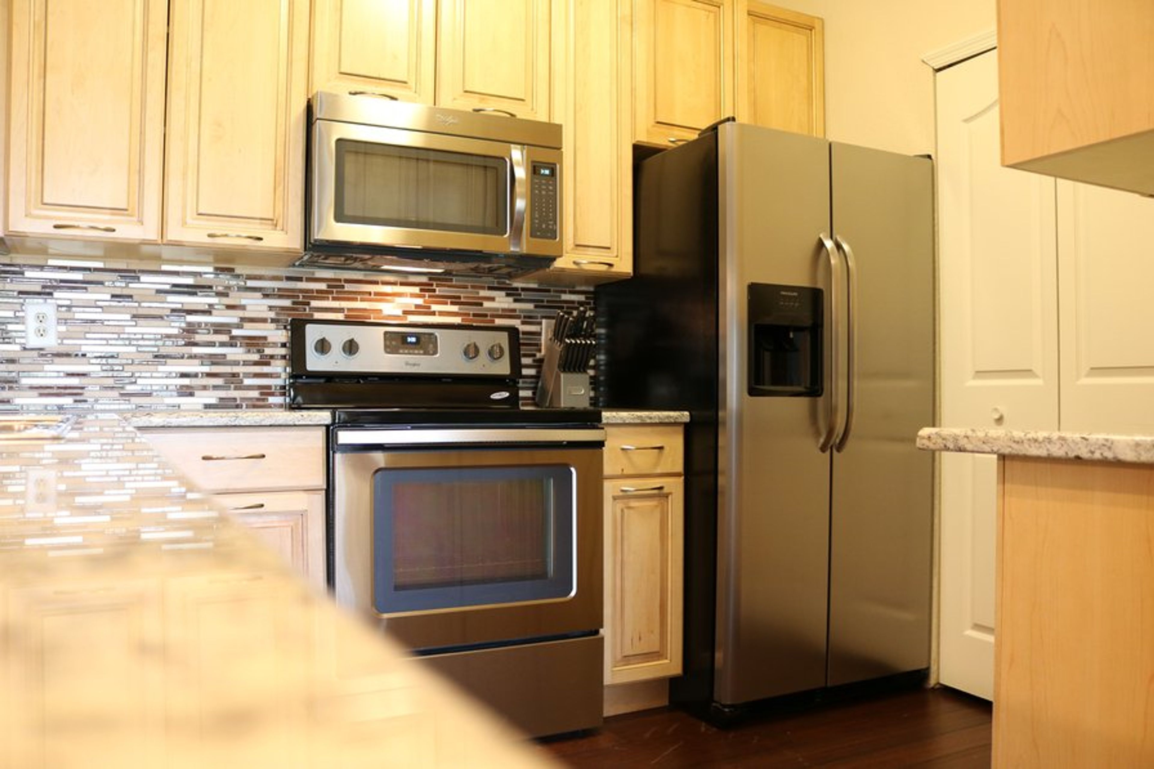 newly remodeled kitchen with maple wood cabinets
