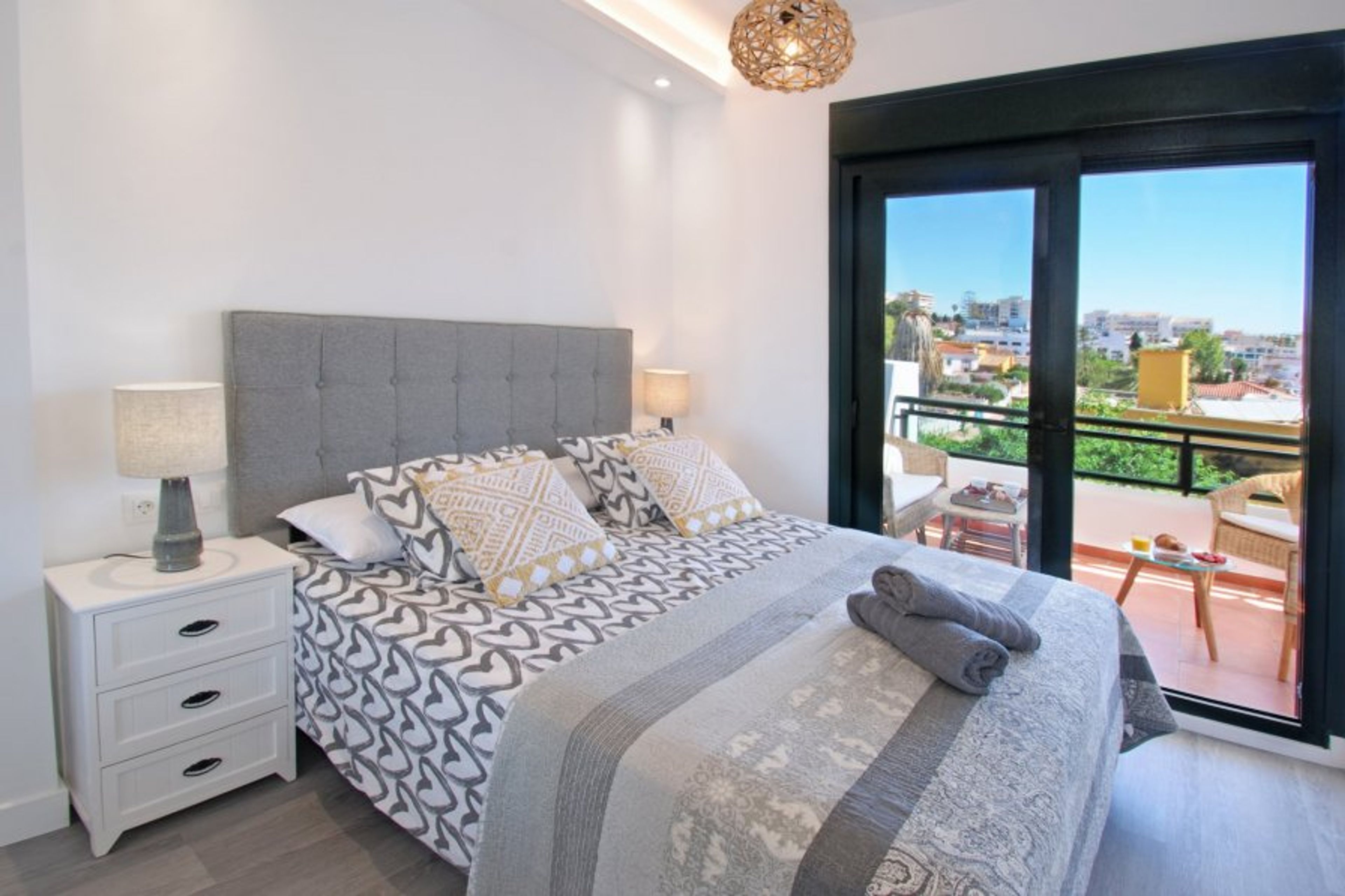 large bedroom with double bed and access to the terrace