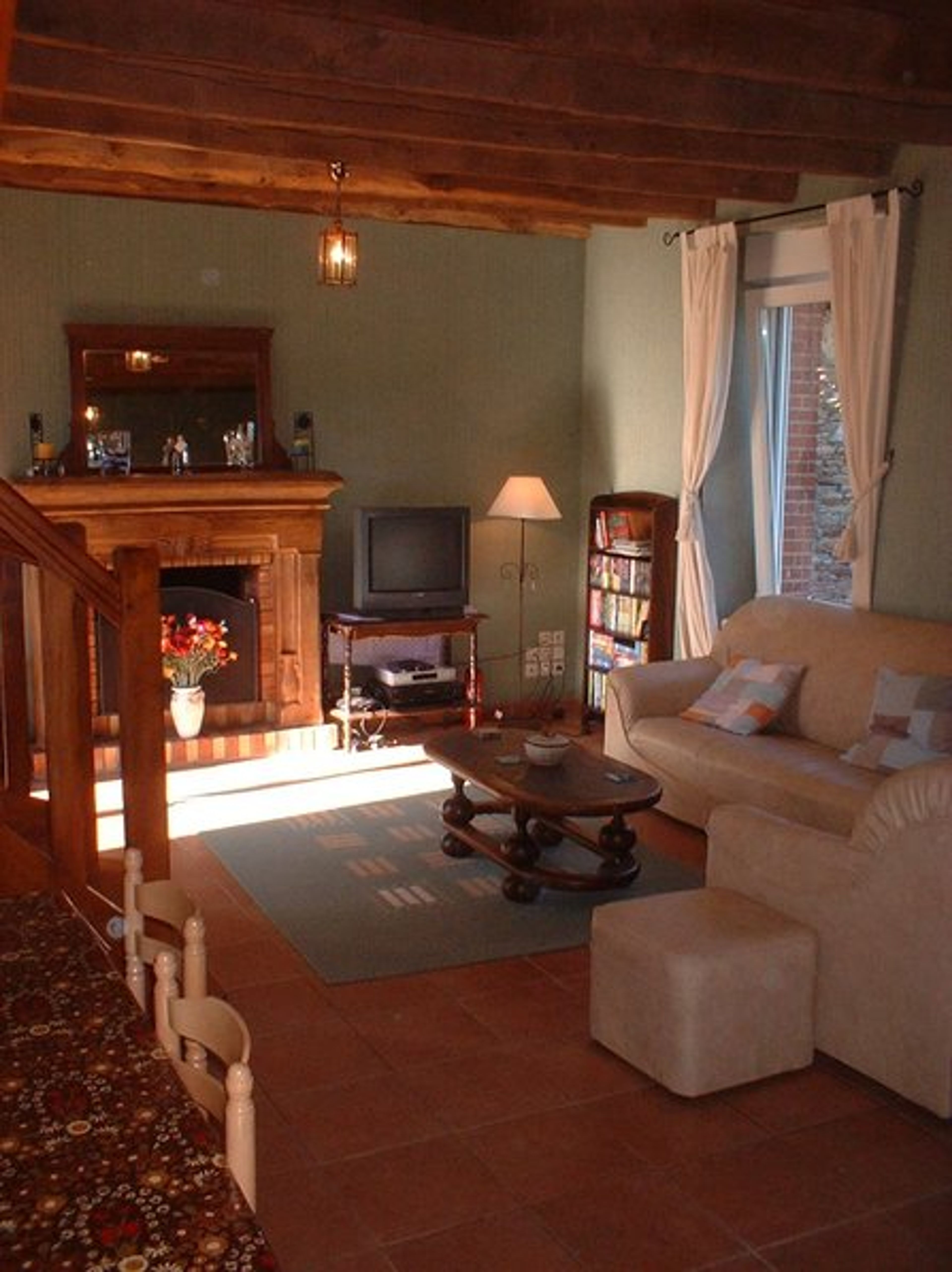 Inside the comfortable lounge with open fireplace and Sky TV