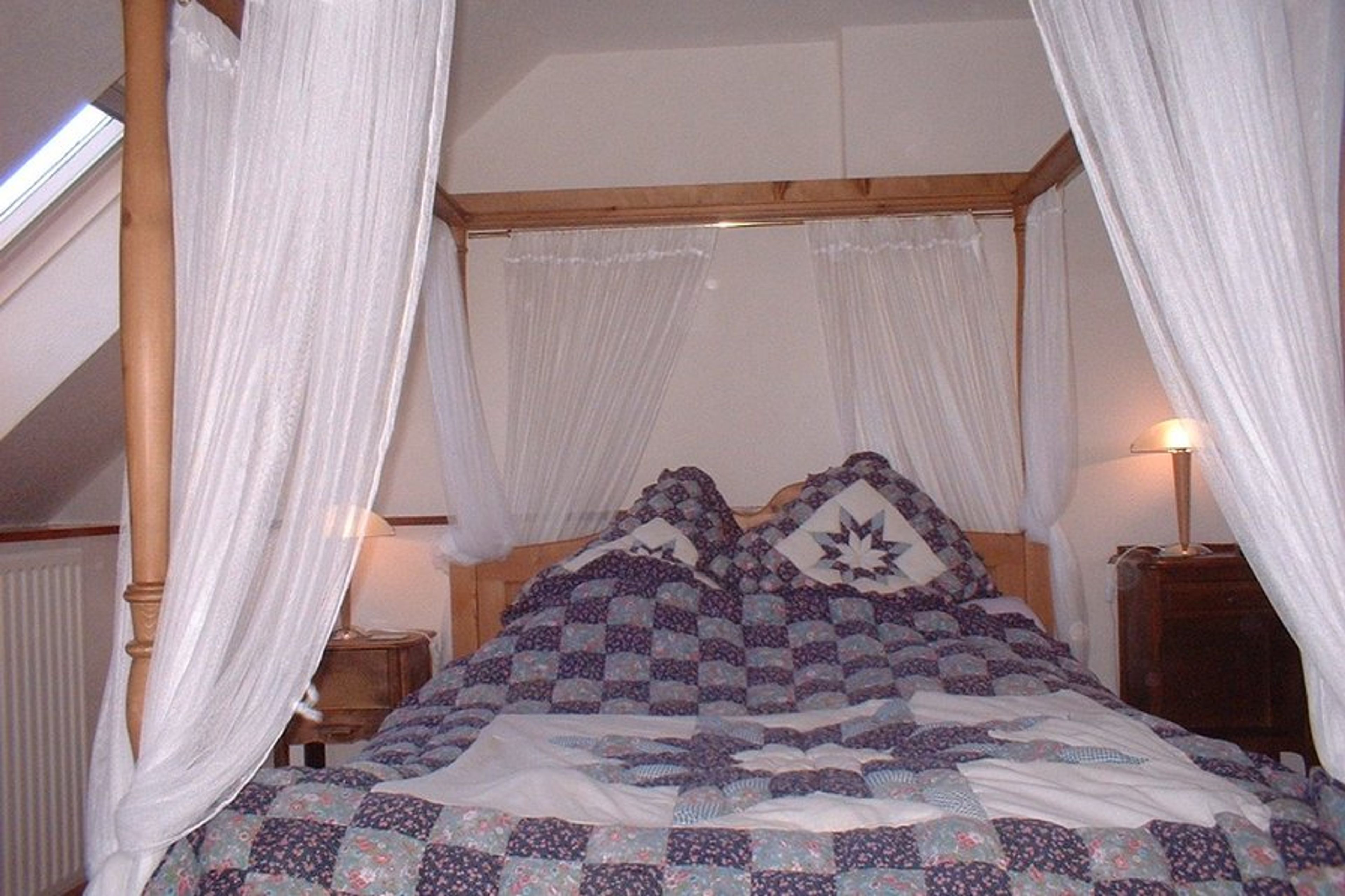 The master bedroom with four poster bed