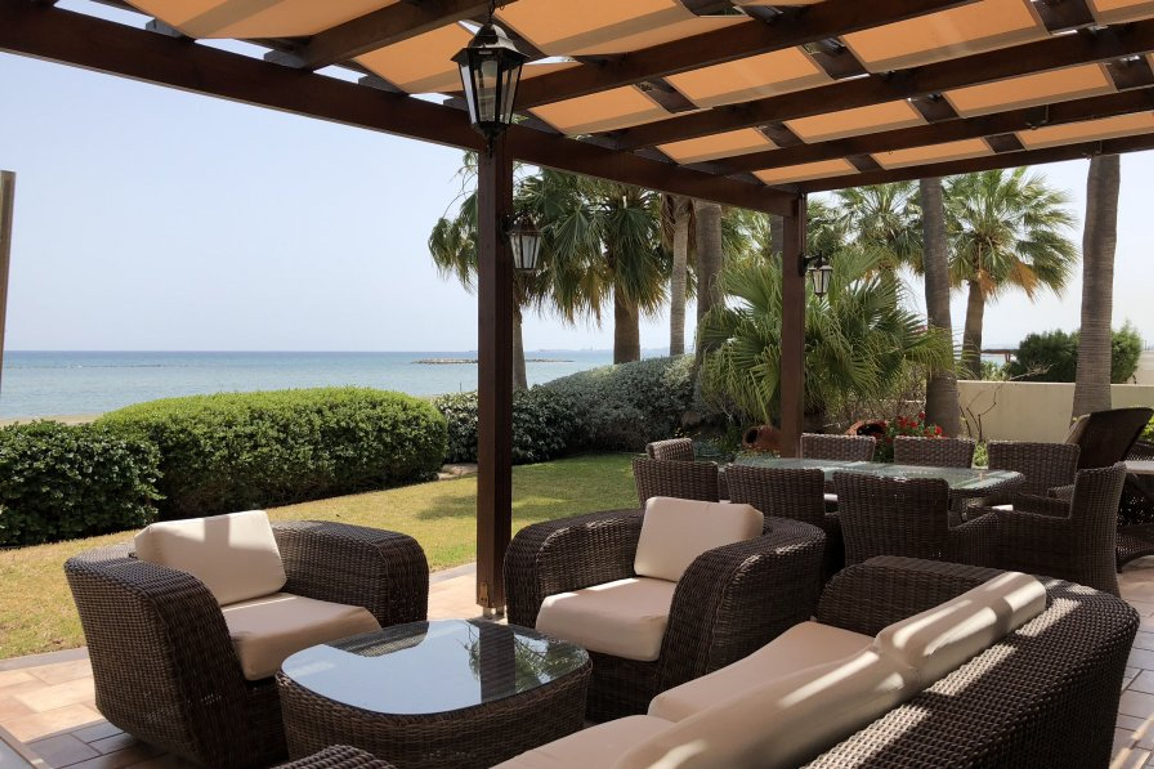 Beachfront terrace with a garden furniture.