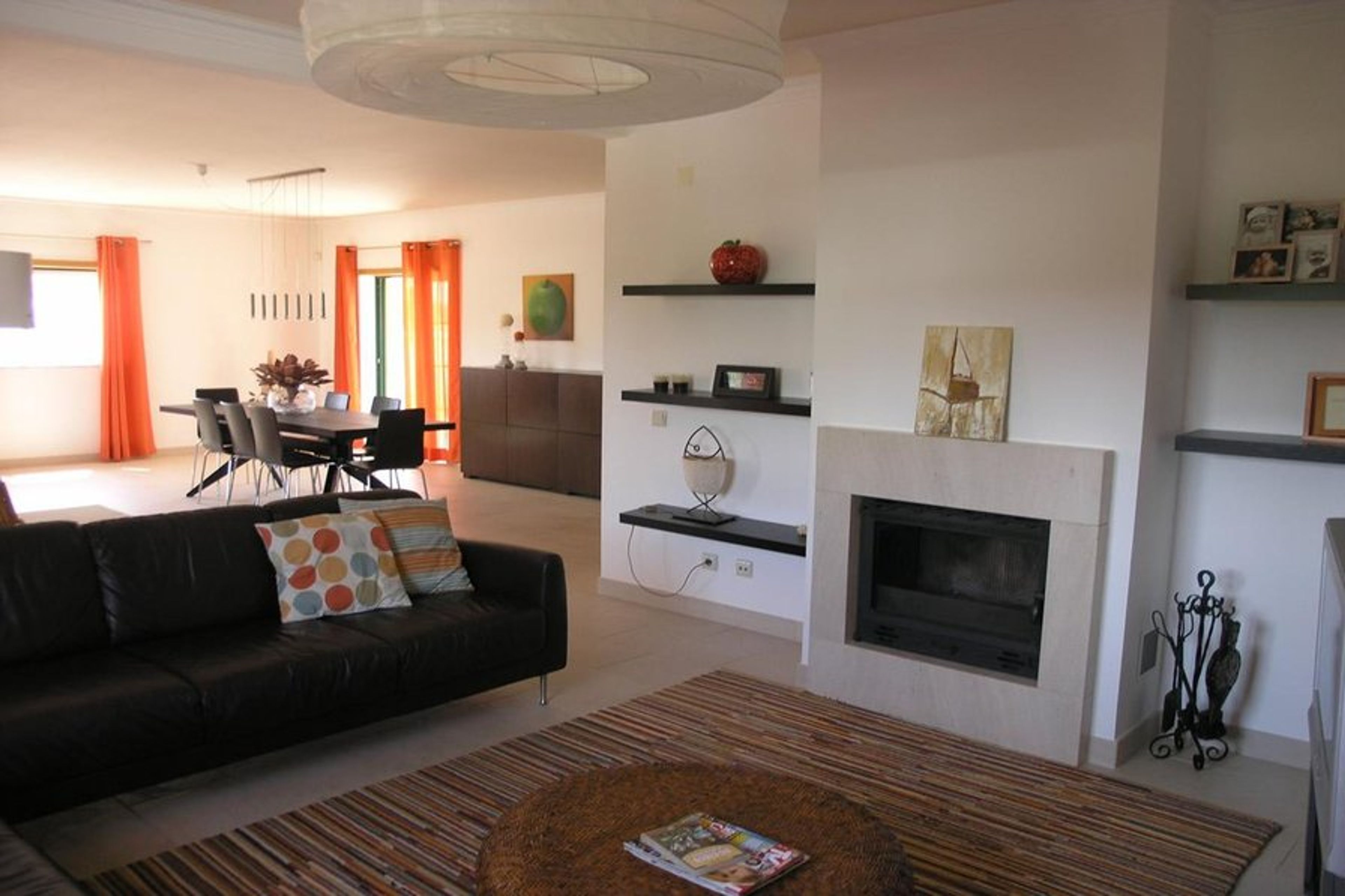 The lounge area with L-shaped sofa, TV and log fire