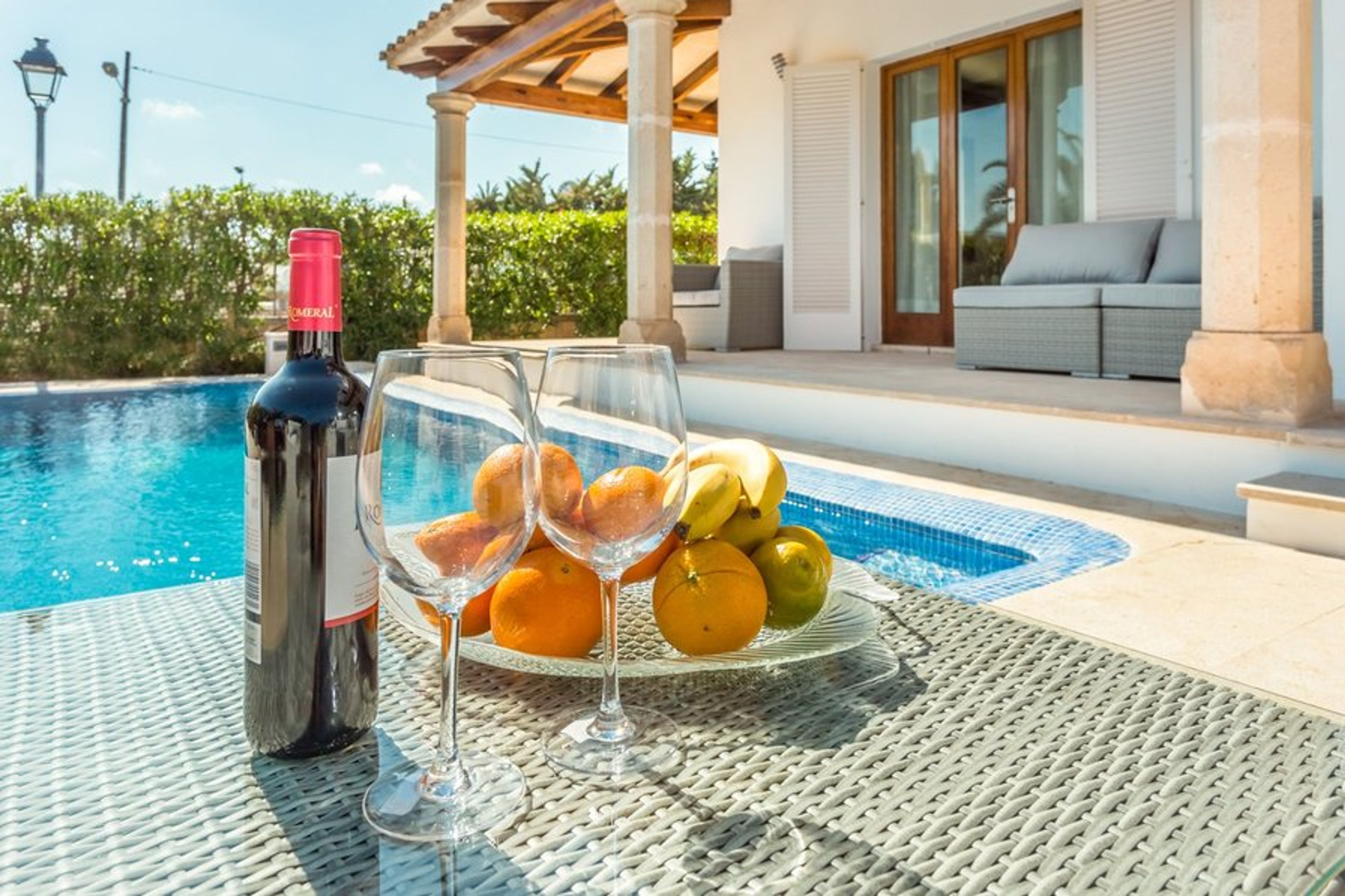Enjoy a relaxing glass of wine by the pool deck.