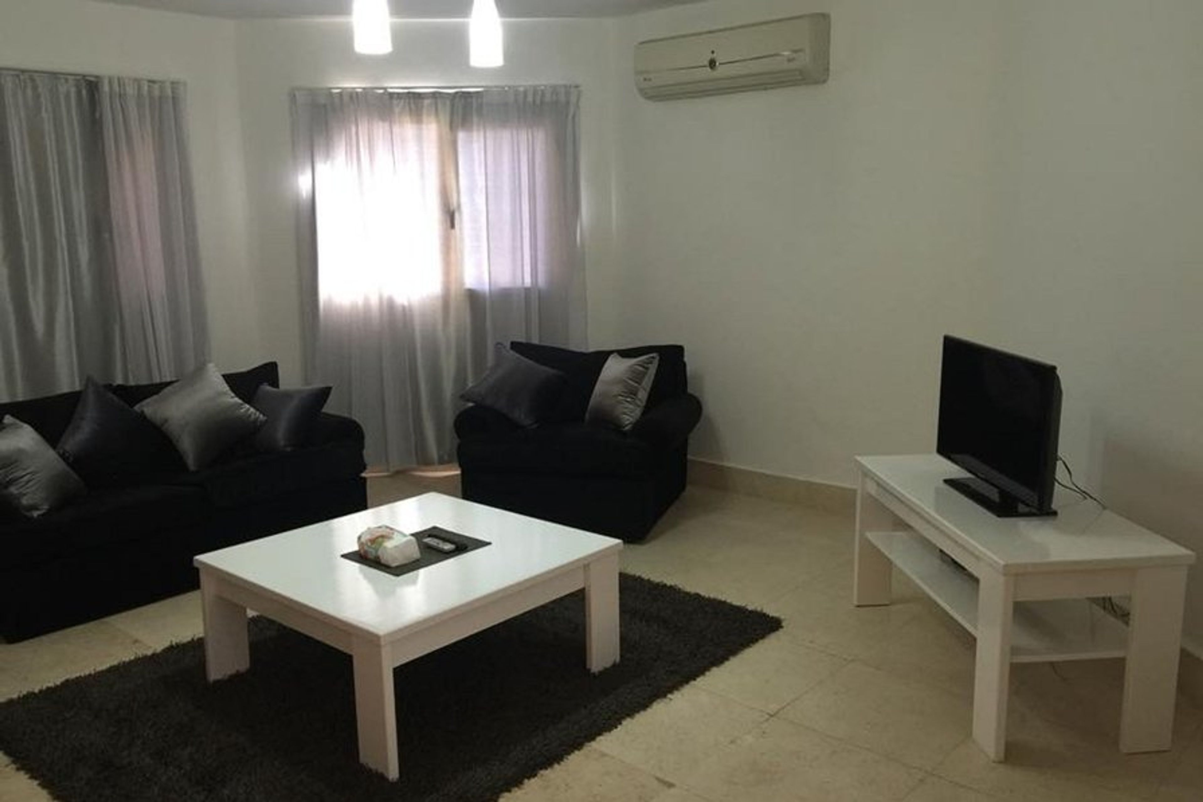 Living area with sofa, arm chair & television with satellite TV