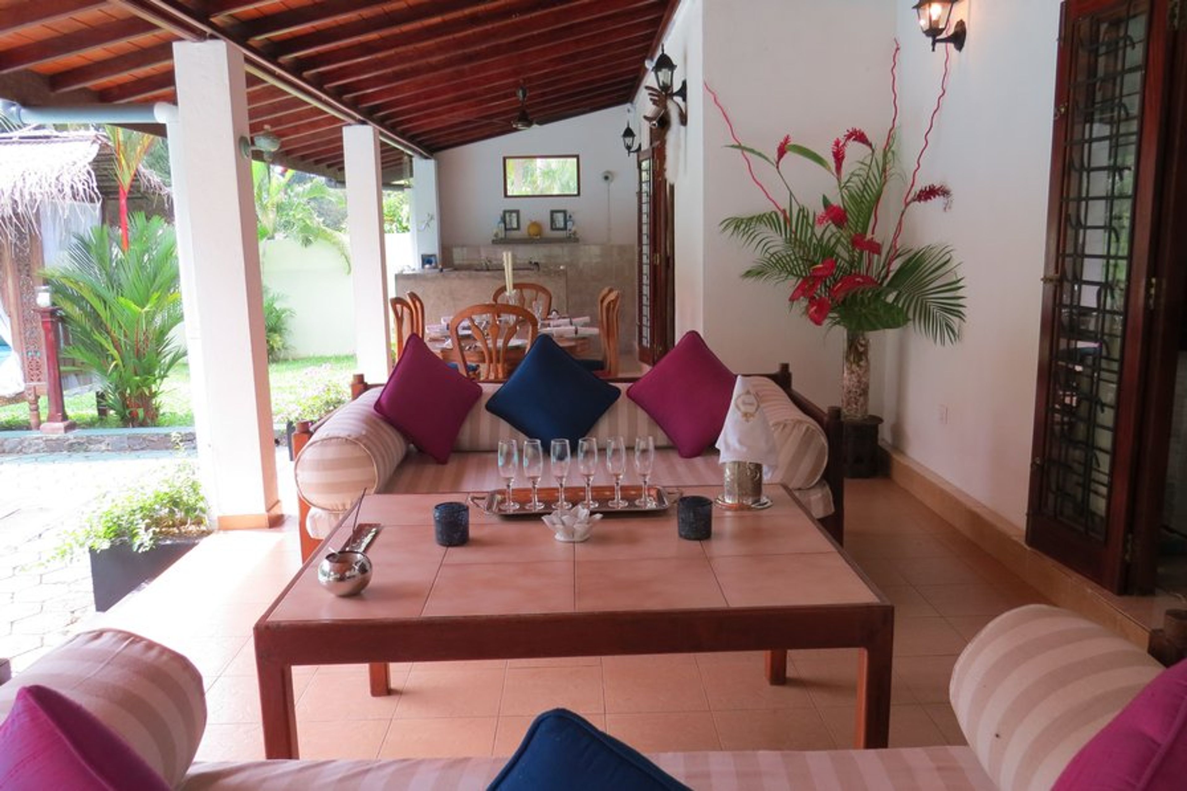 Shaded verandah outdoor living area with Sofas, coffee table and bar