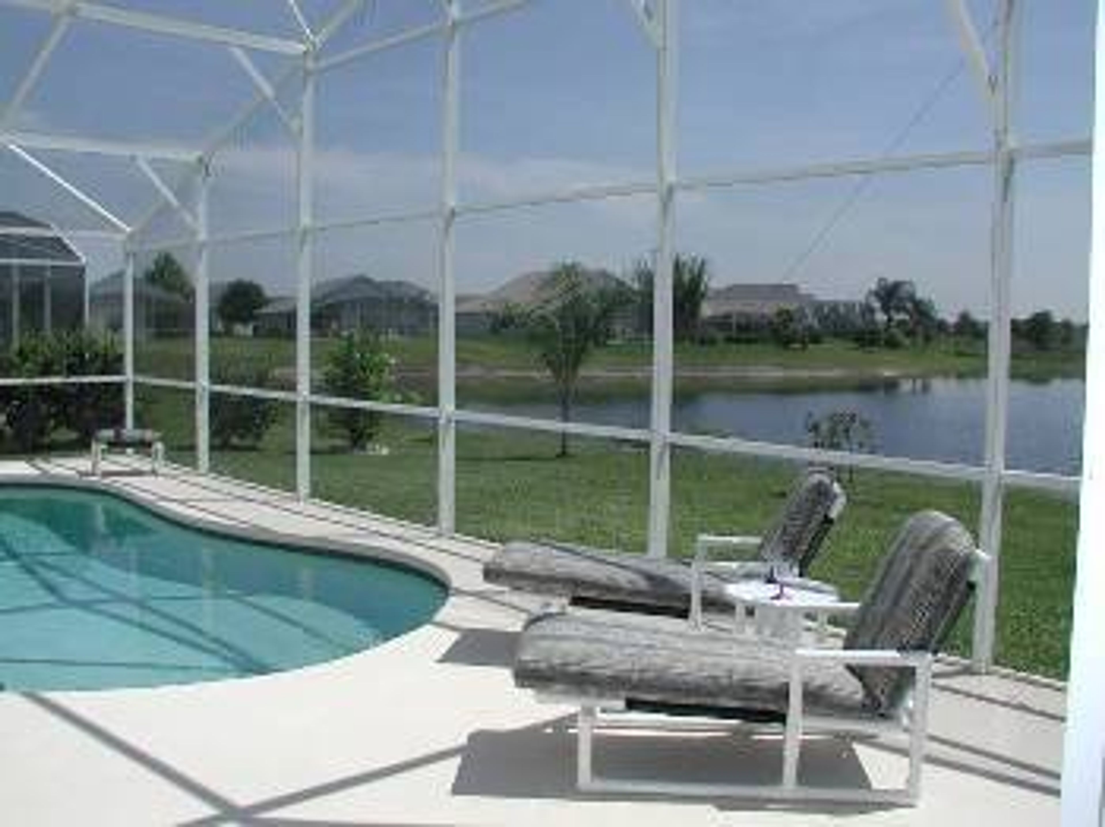 View over lanai to pool and lake beyond