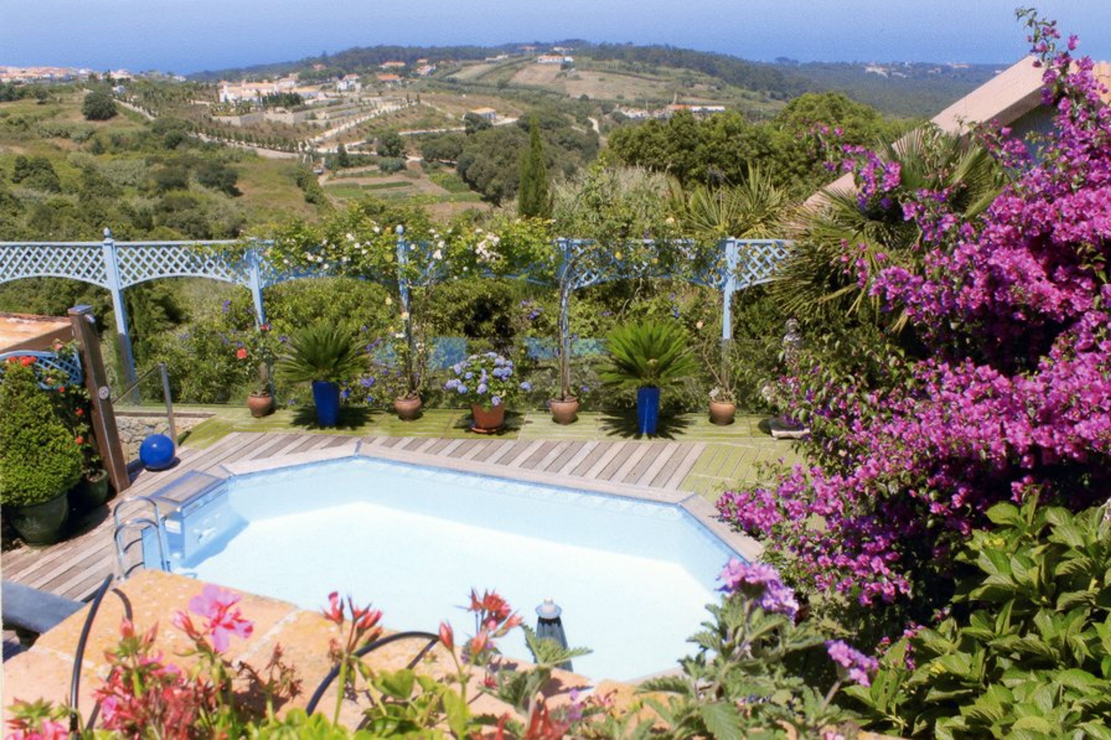 Swimming pool with view down valley to sea