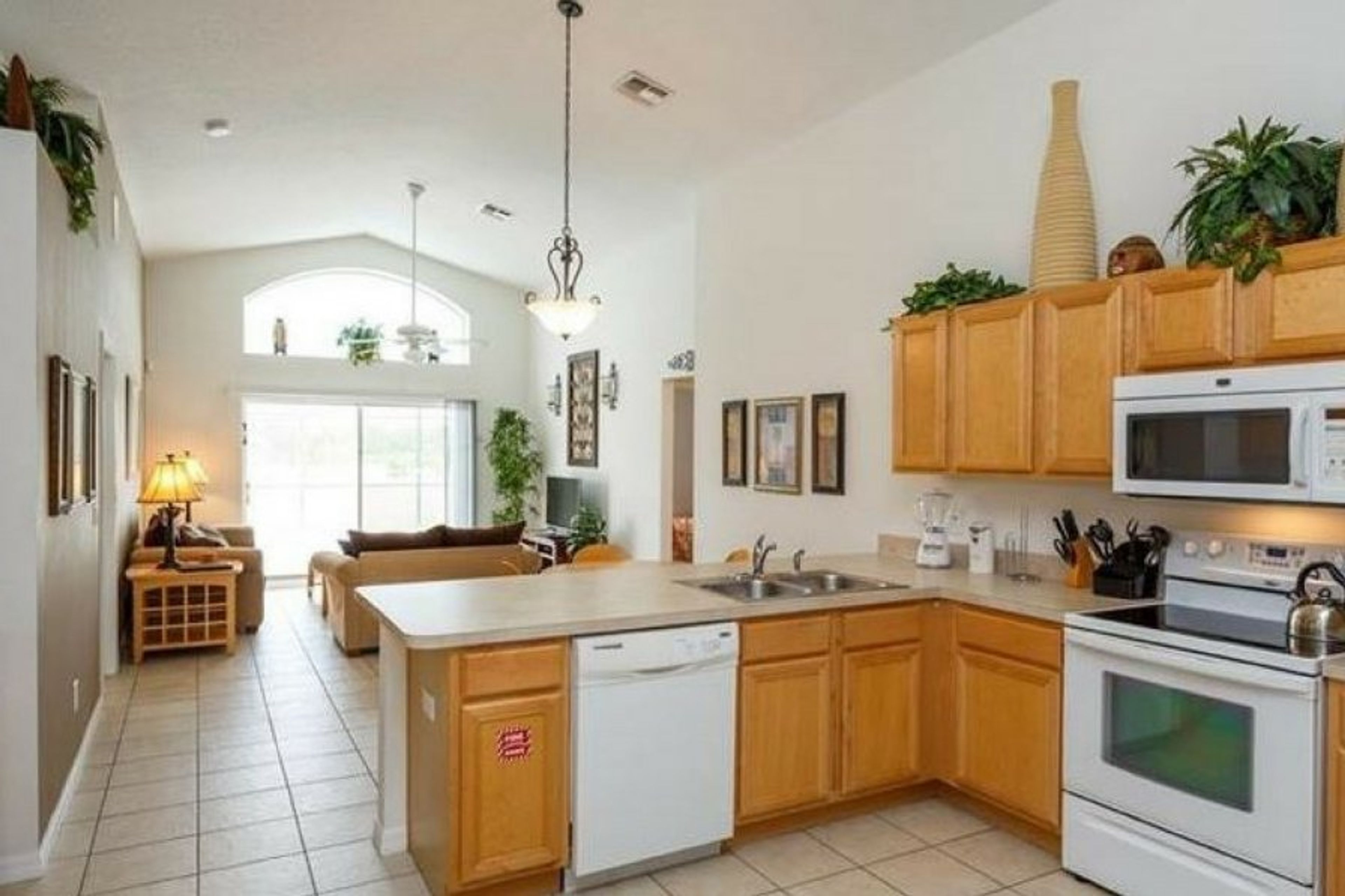 Well equipped kitchen overlooking the pool and patio area.