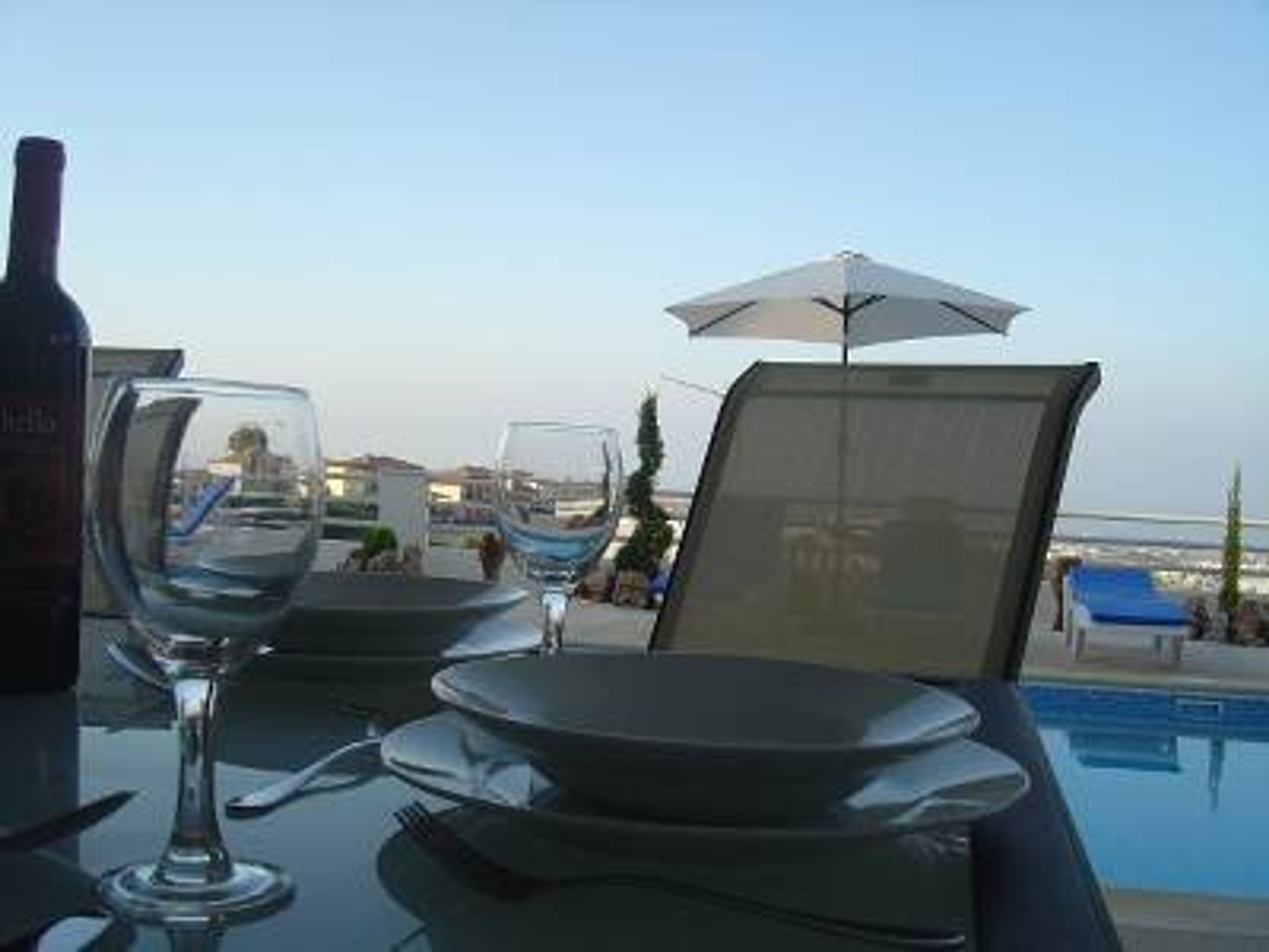 Patio with sea and pool view dining 6-8. High Chair as well