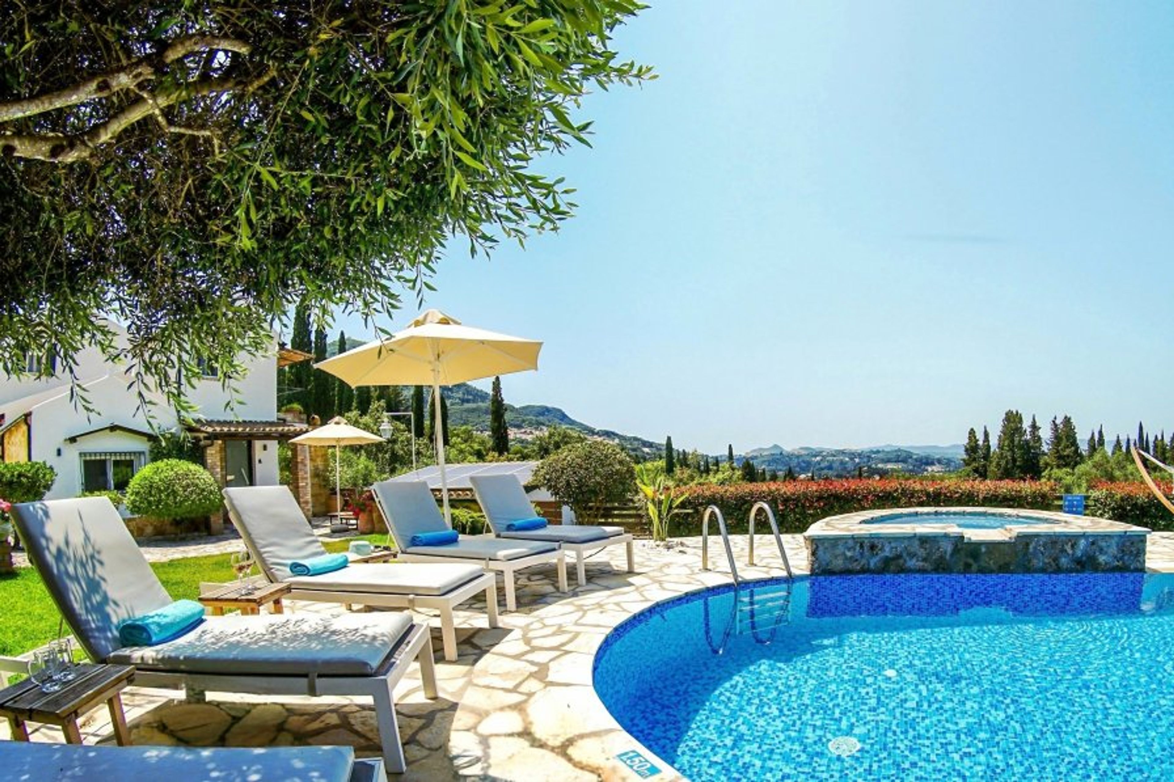 Sunlit loungers curving around a crystal-clear basin