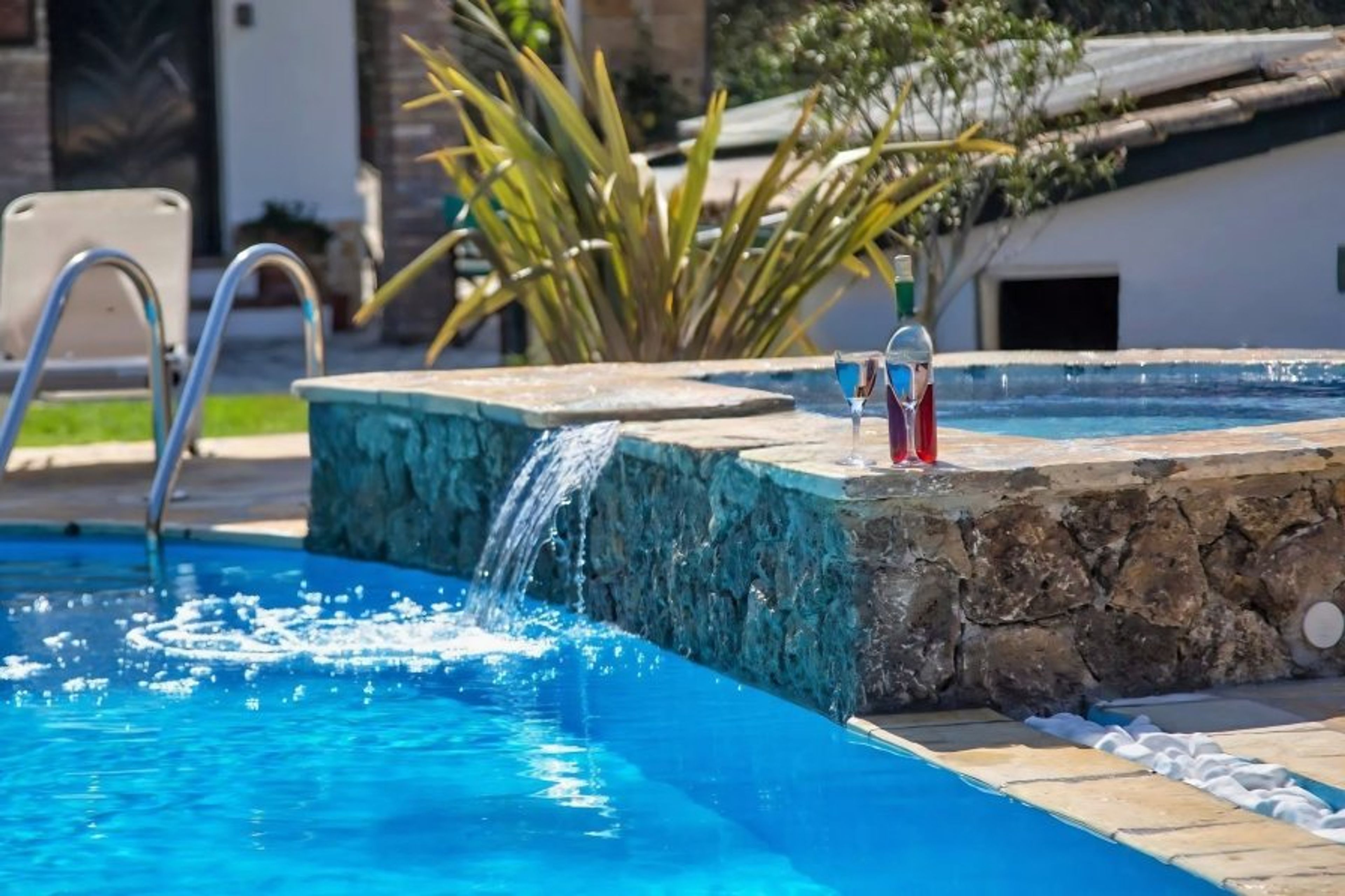 Private plunge pool with stone details and crystal-clear water