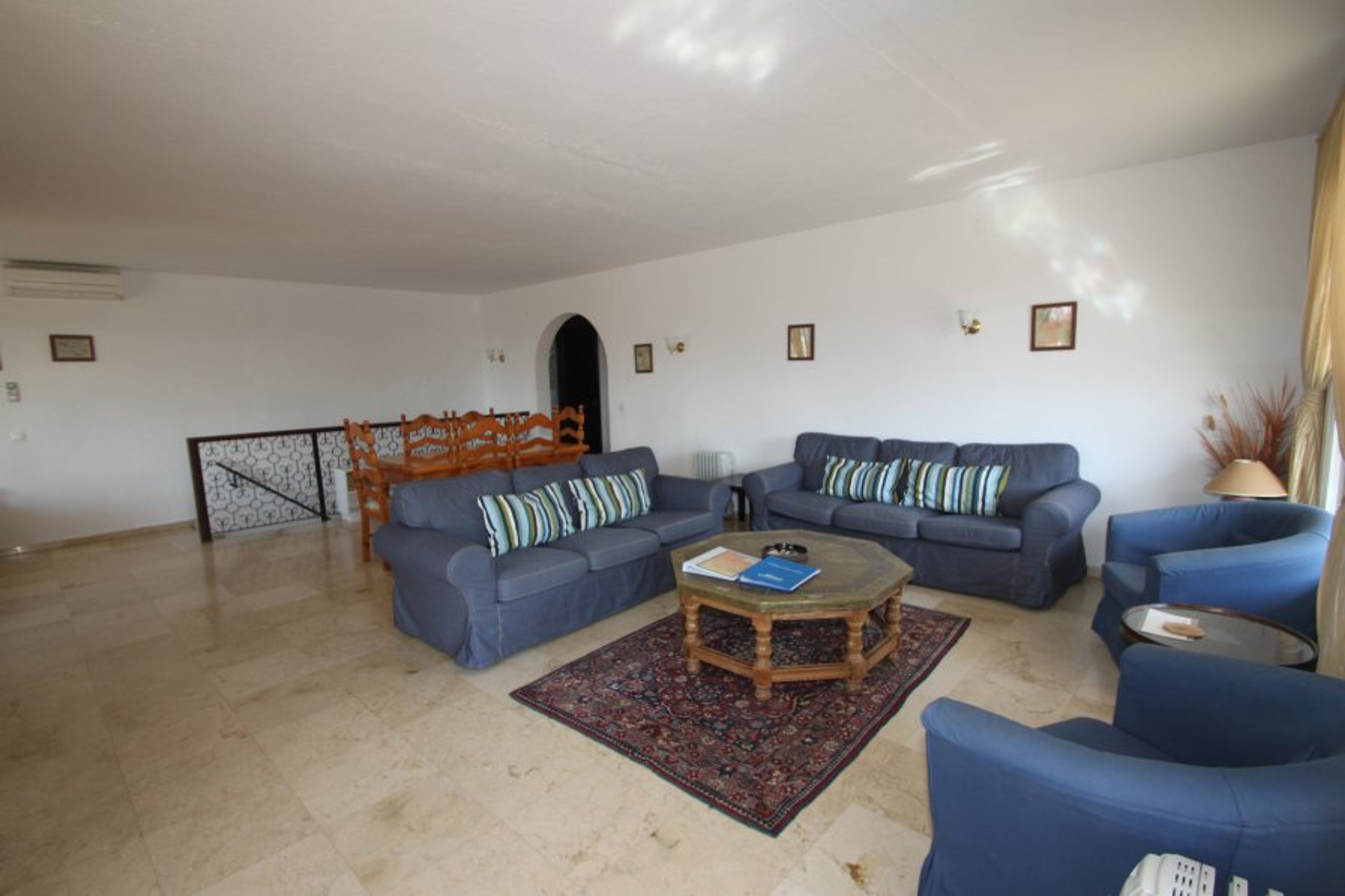 Spacious lounge & dining area with access to terrace overlloking pool.