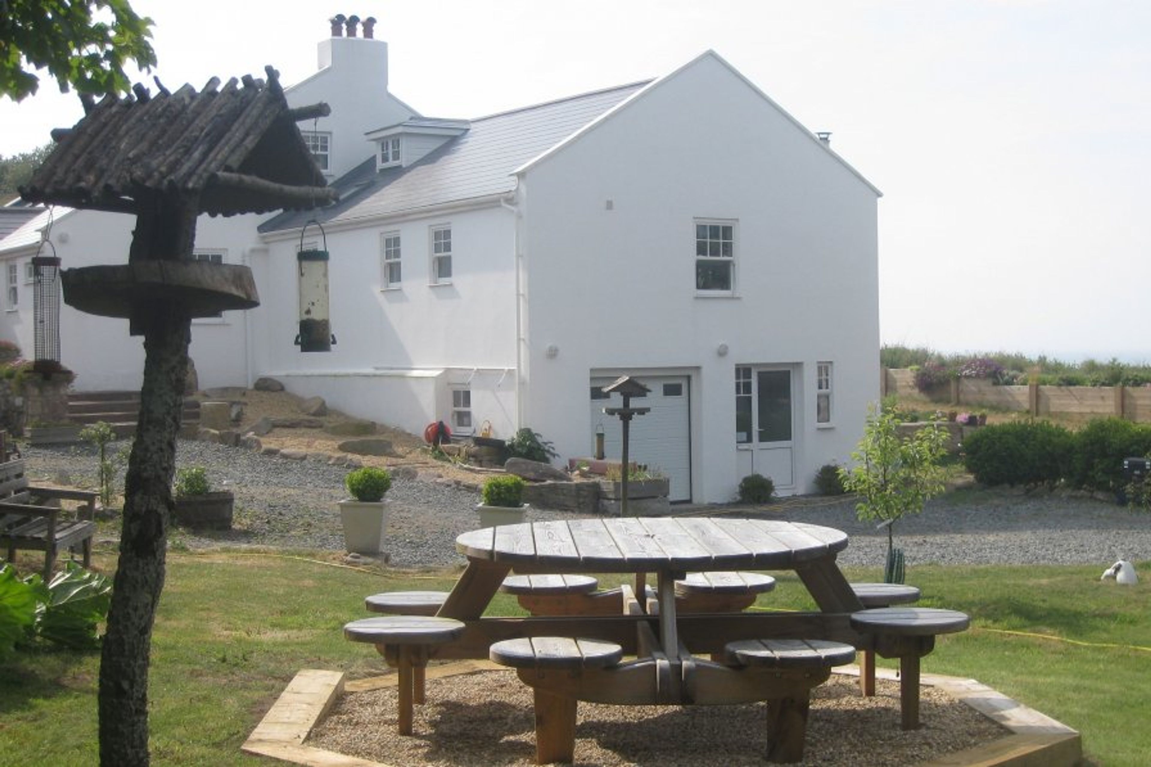 Cottage garden area, entrance and sea in background