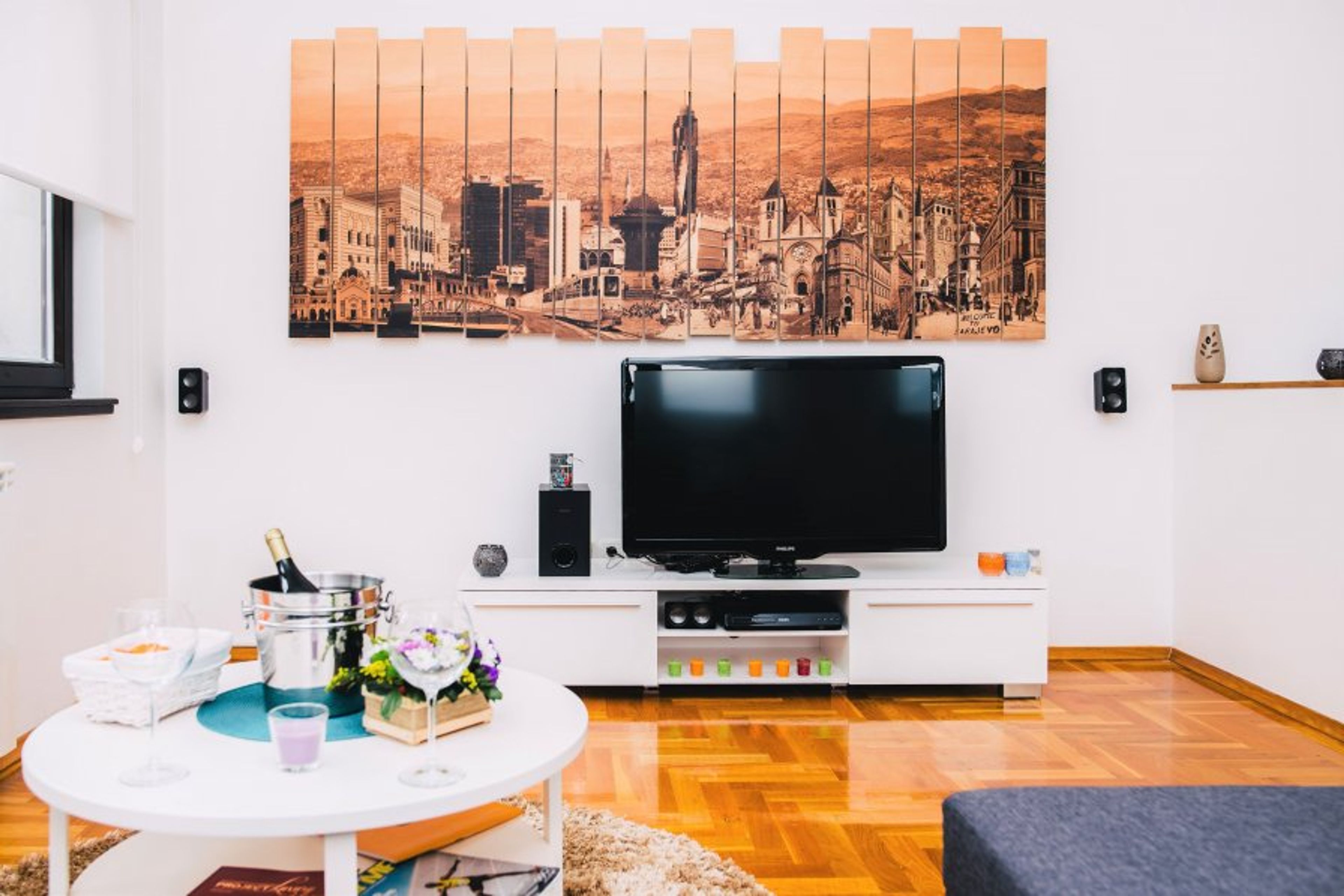 The living room decorated with a beautiful artistic landscape of Sarajevo 