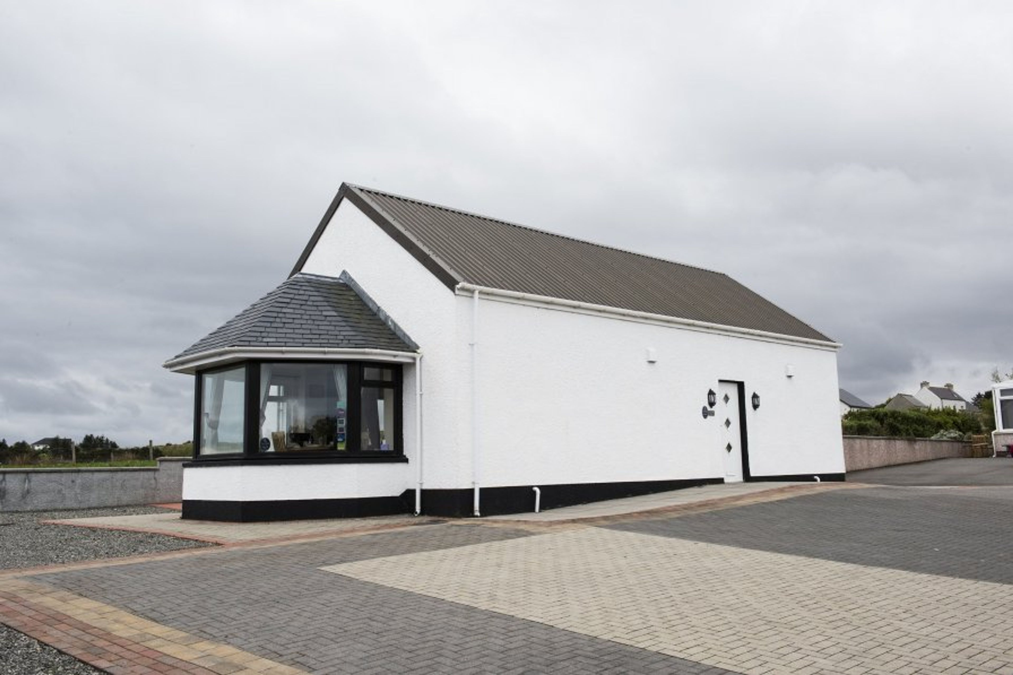 Front of cottage showing accessible entrance and parking.