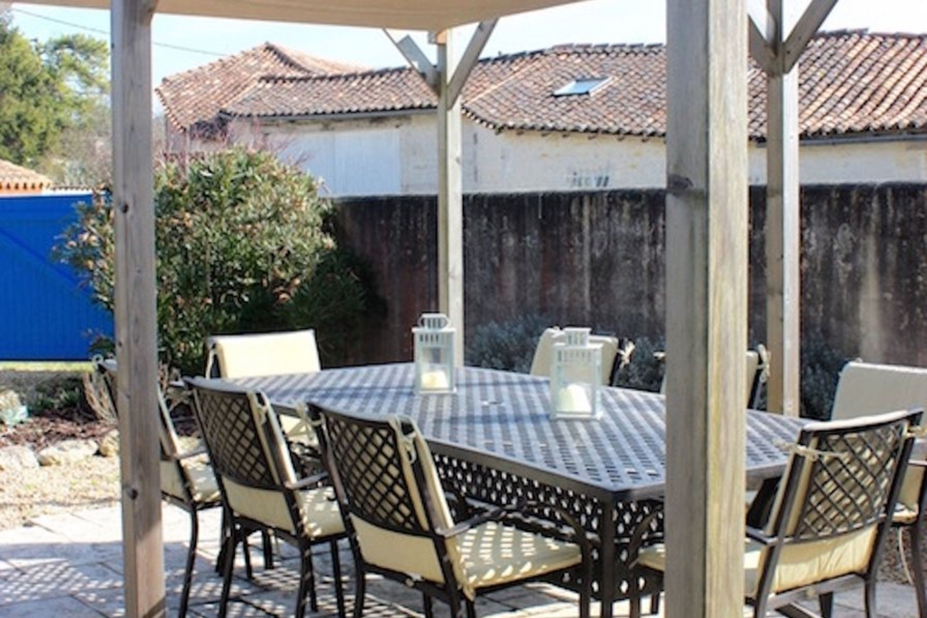 The outside patio is shaded by sails with a generously sized table.