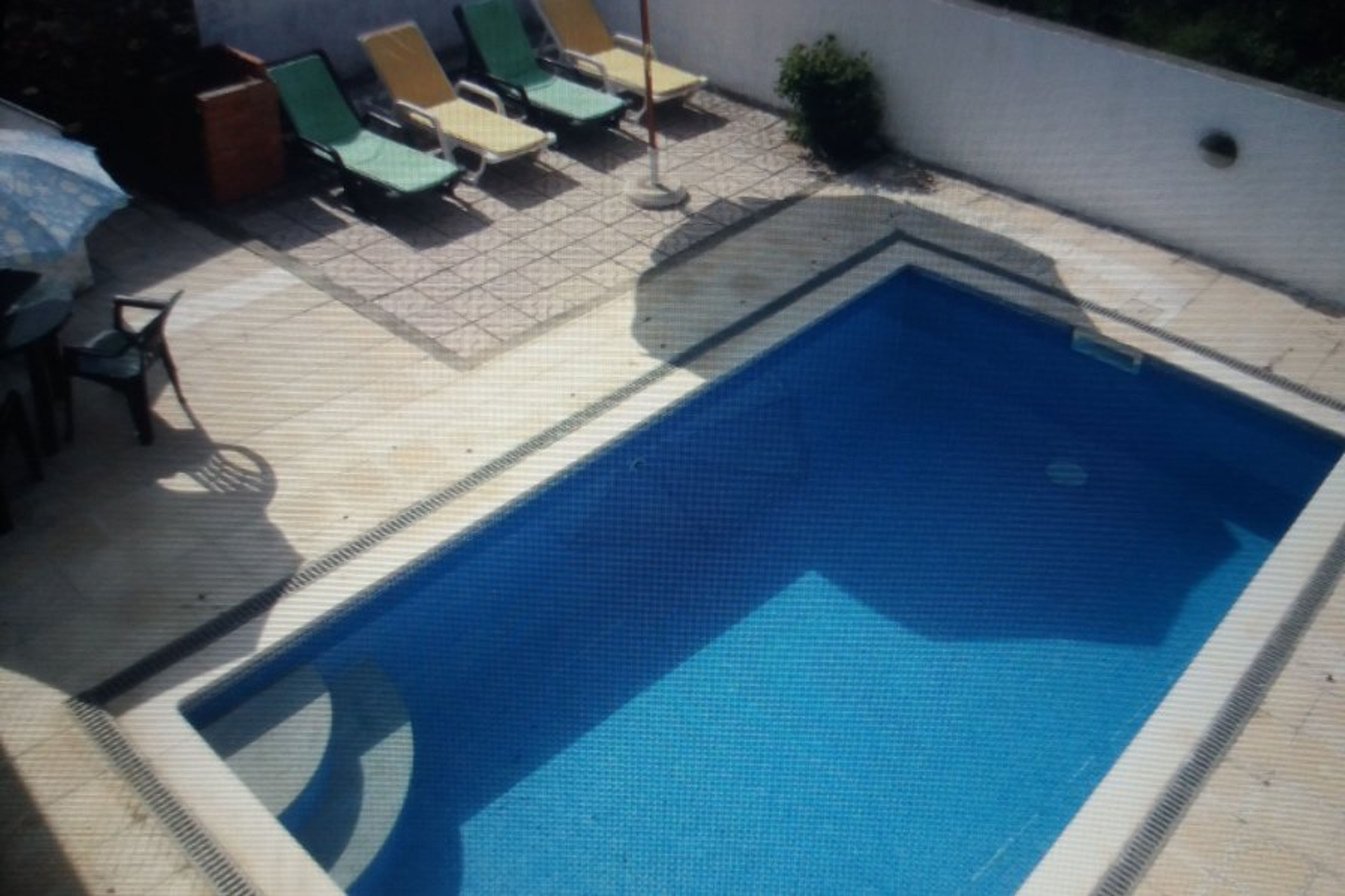 Pool and outdoor lounges with seating area.