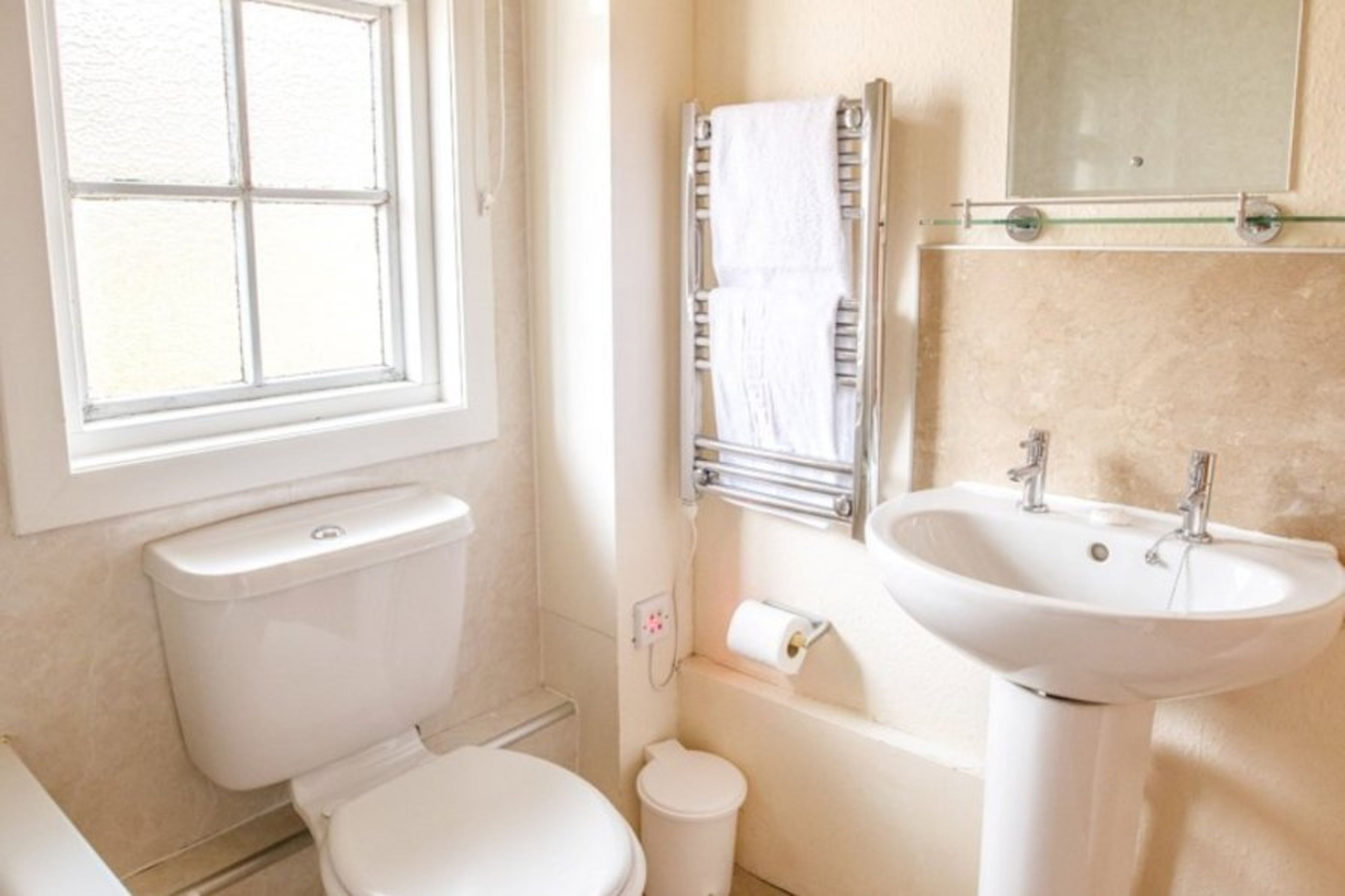 The downstairs bathroom with shower over bath