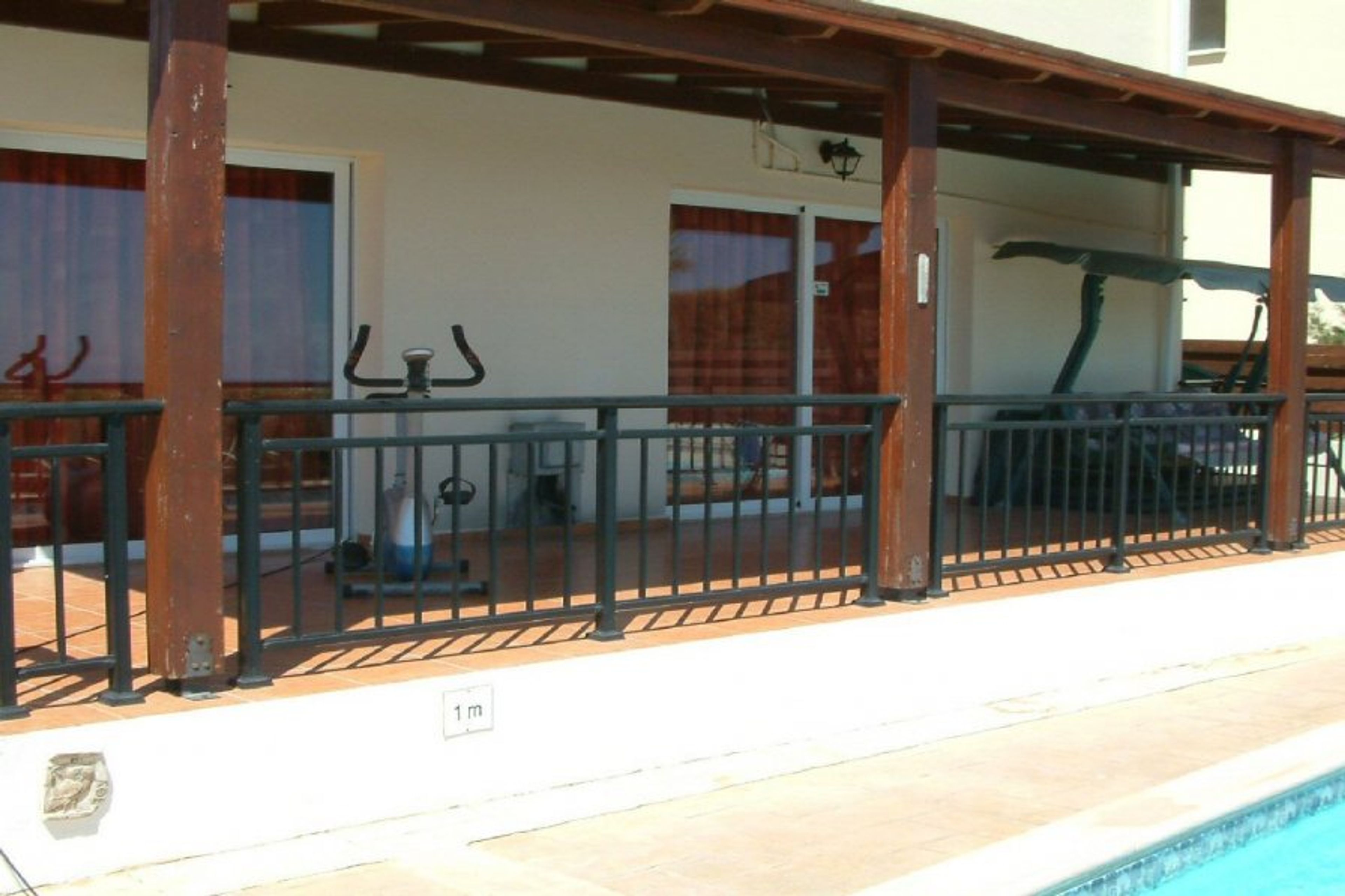 Shaded patio with swing hammock and exercise cycle