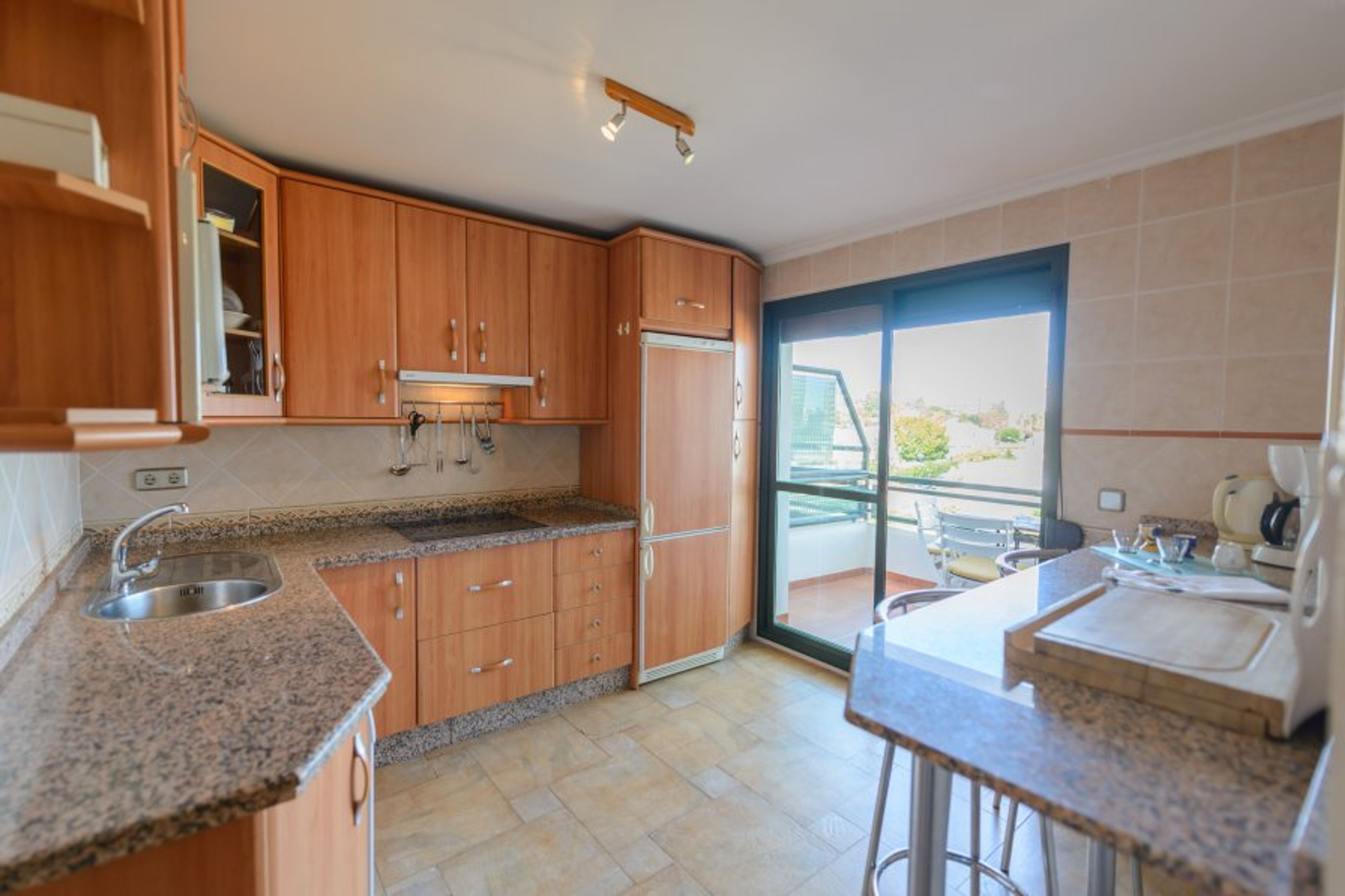 Fully equipped kitchen and doors to the second terrace