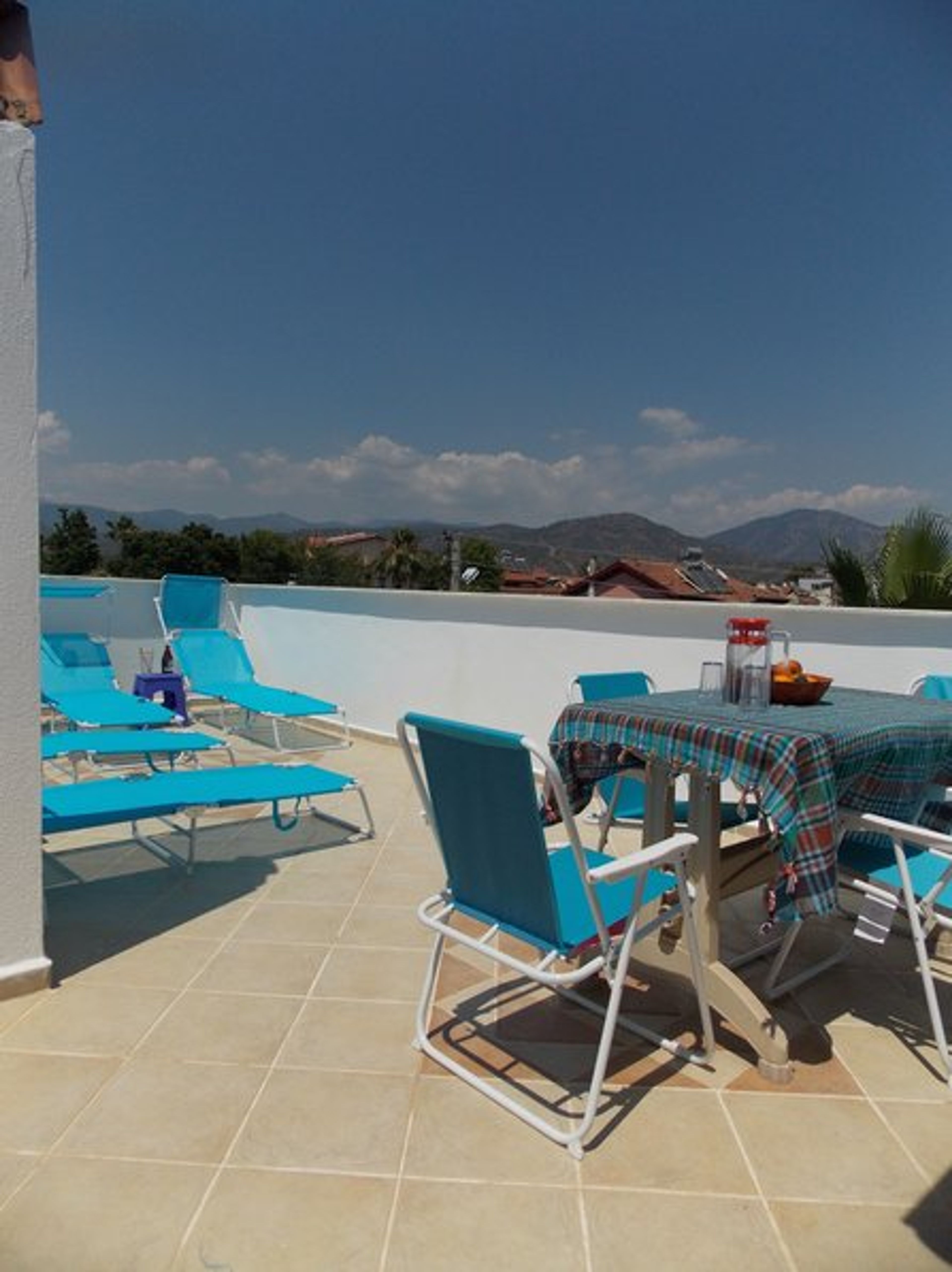 partial view of large roof terrace from door of utility area