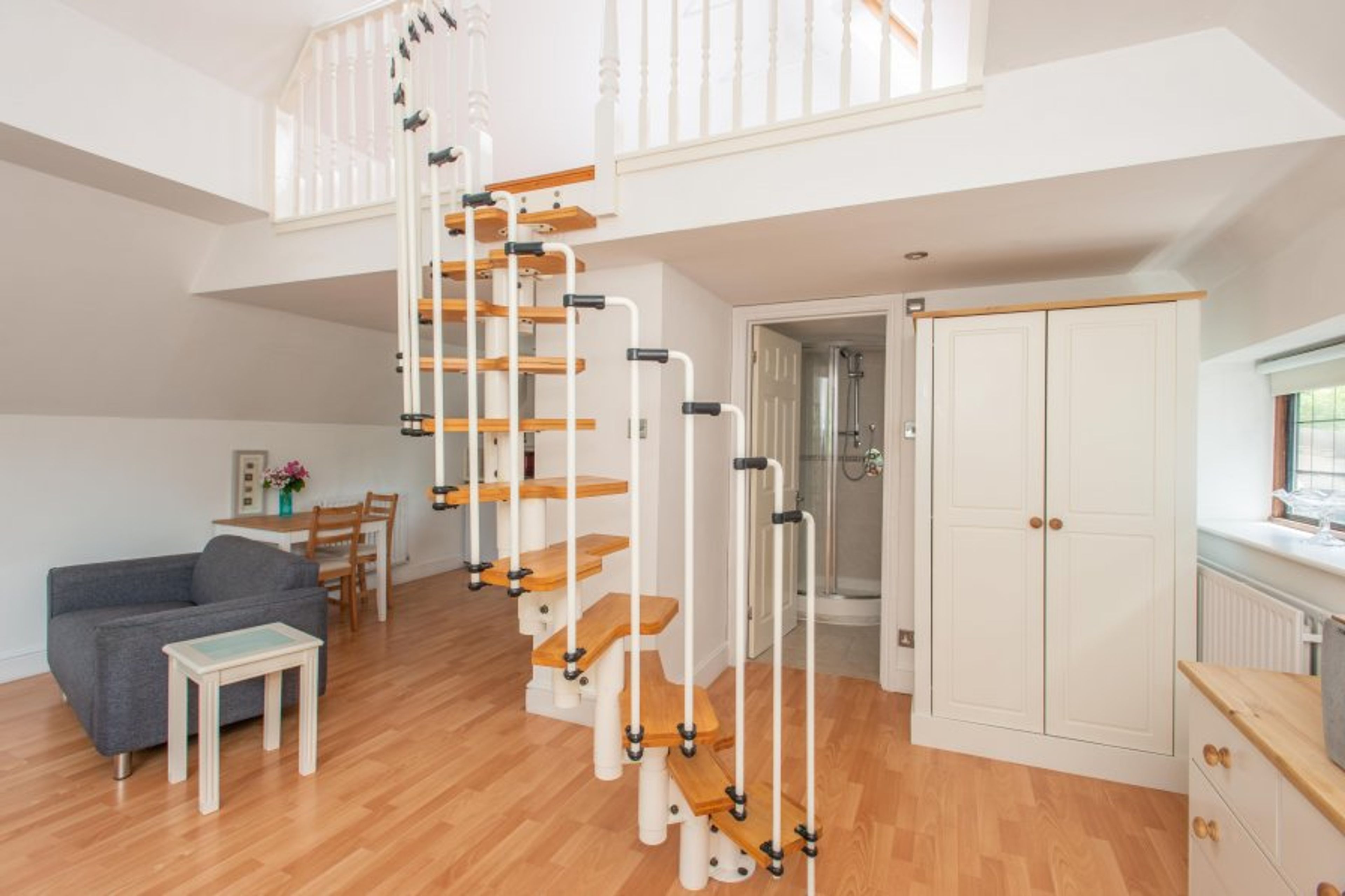 Spiral staircase to mezzanine bedroom.