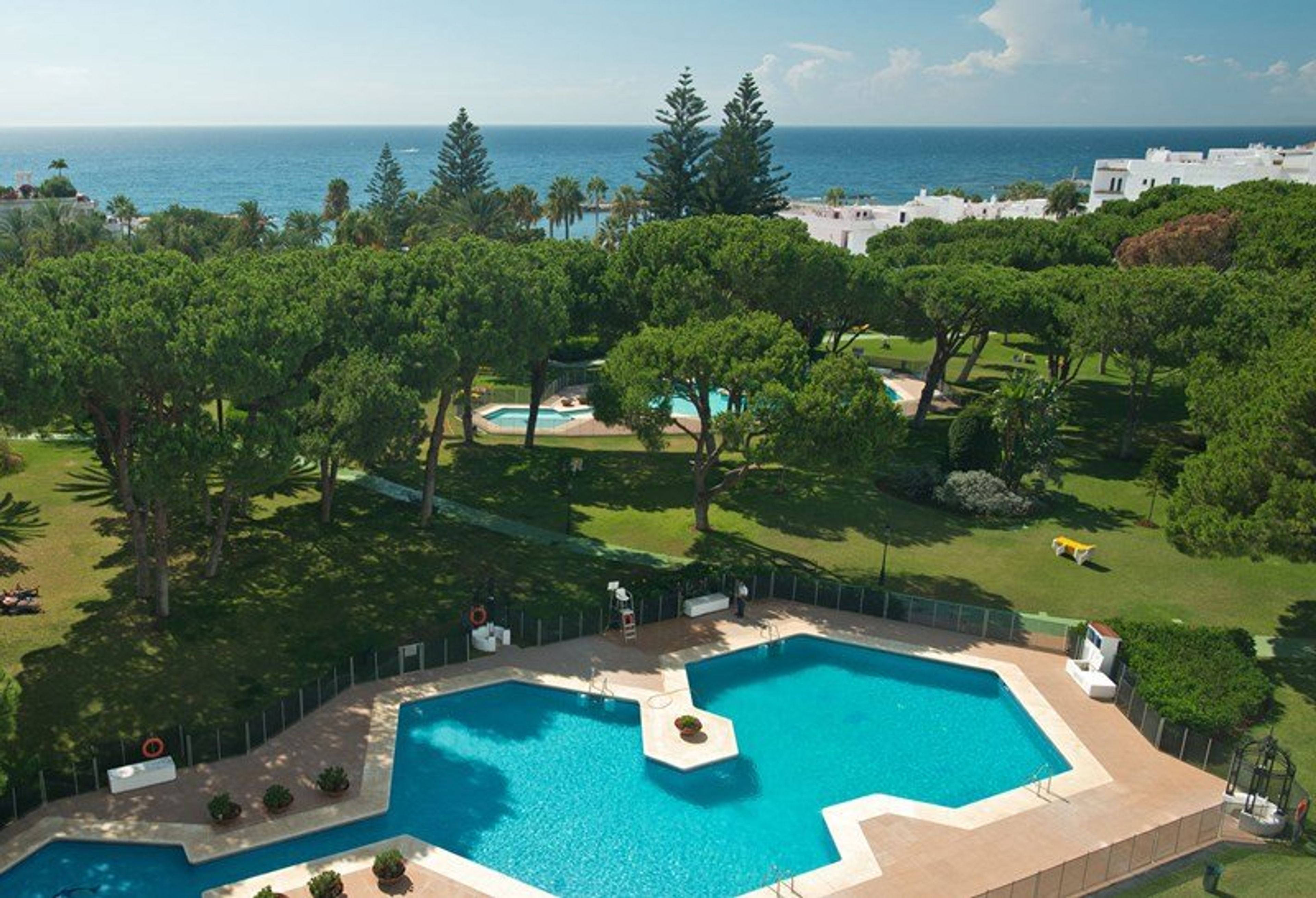 Partial aerial view of Club Playas Del Duque gardens and beach in Puerto Banus