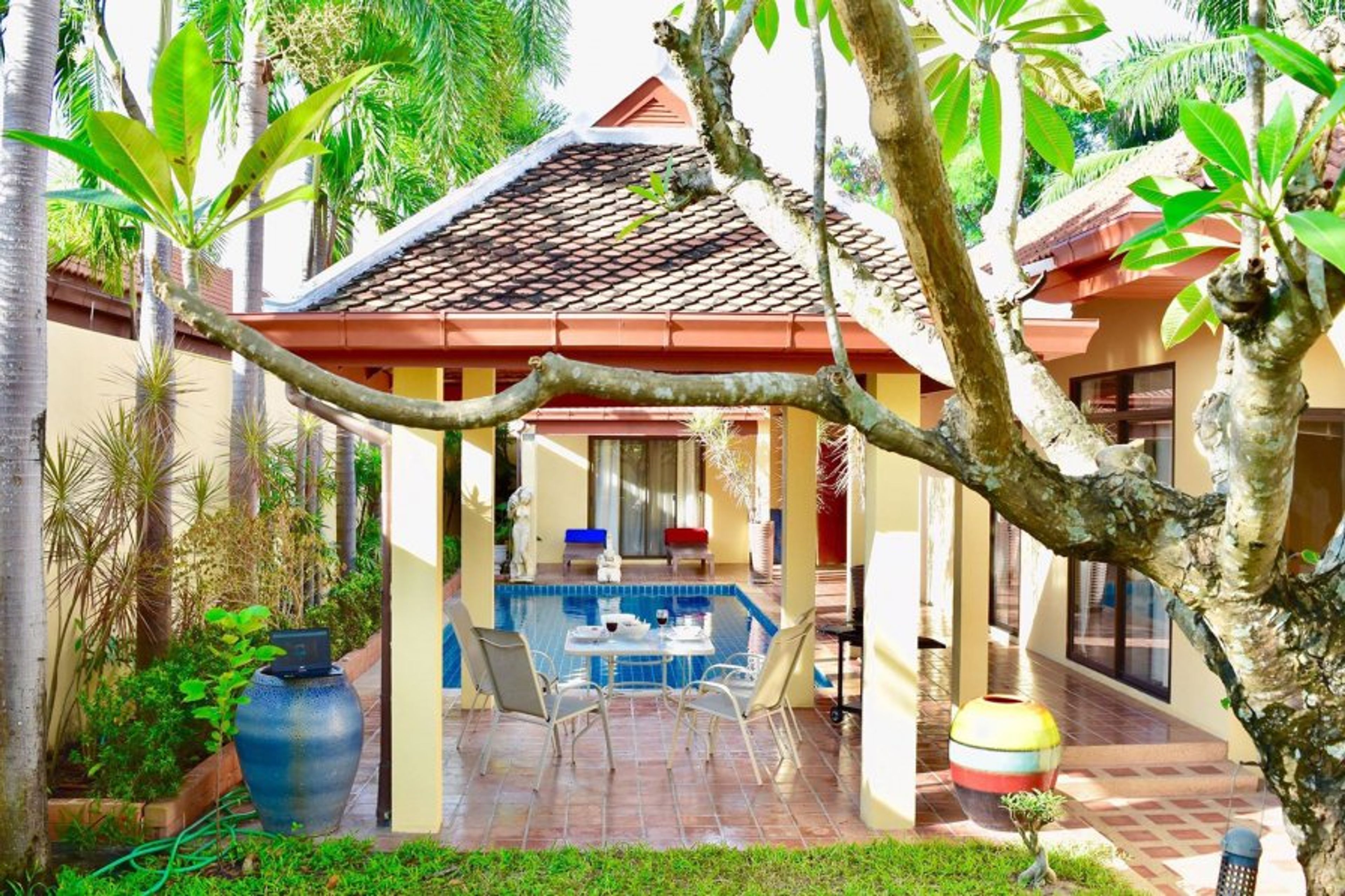 Views of the pool and sun deck surrounded by lush tropical gardens.