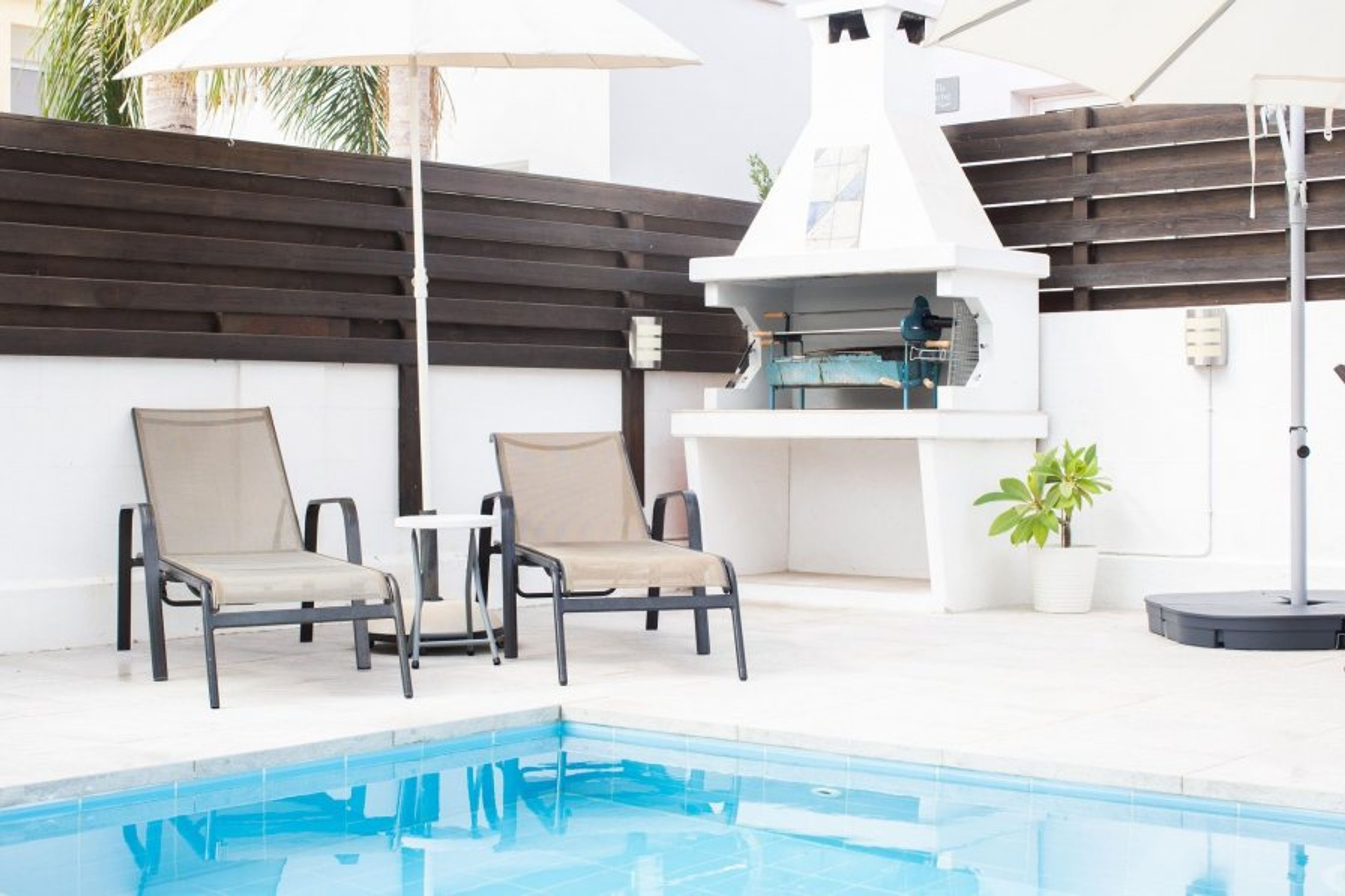 Barbecue and sun loungers.